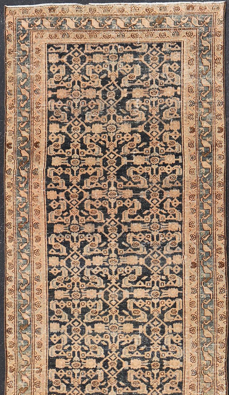This antique Hamedan was hand-knotted in Iran during the 1920's. The center field displays a Herati design, nicknamed the 