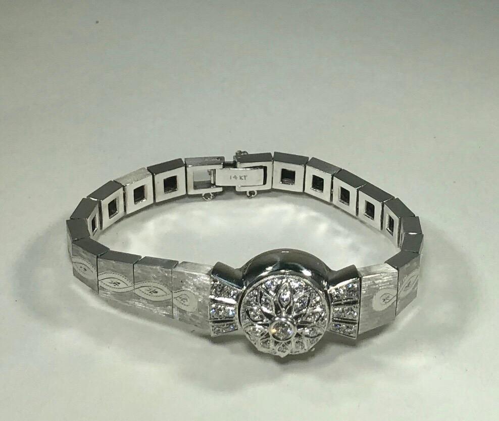 Antique Hamilton 14 Karat White Gold and Diamond Watch Circa 1950. This One of a kind antique Hamilton watch is created in solid 14 karat white gold. This piece is adorned with 33 Full cut diamonds = .88 carat total weight, average color H, average