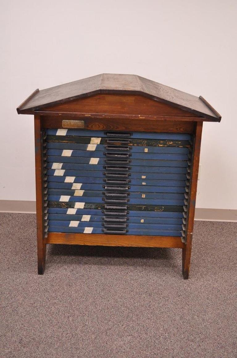 Antique 16 drawer oak Letterpress display/storage cabinet by the Hamilton Manufacturing company. Item features removable top, 16 drawers, solid oak case, original metal Hamilton Pulls, and sectioned interior for drawers (Five-drawers are missing the