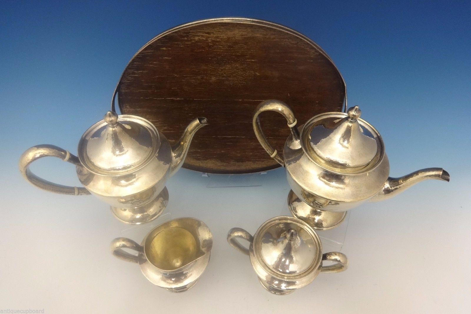 Antique Hammered by Shreve
Arts & Crafts Antique Hammered by Shreve 5-piece sterling tea set. The set has an applied S monogram and is marked with #3752. The set dates from circa 1915. It includes: Coffee pot: Holds 2 pints, and it measures 8 tall,