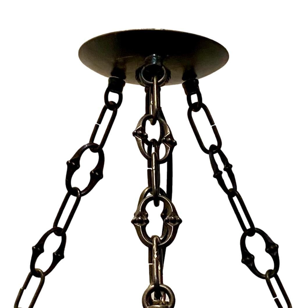 A circa 1920's French hammered iron light fixture with three interior lights.

Measurements:
Diameter: 13