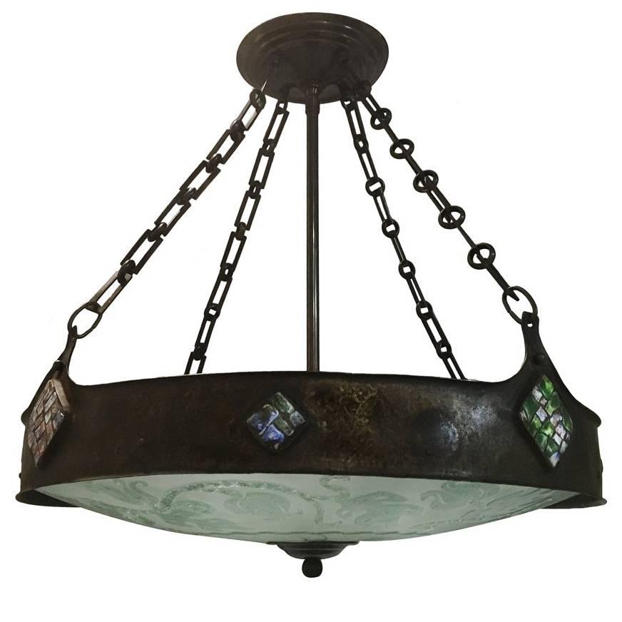A Danish circa 1900s hammered metal fixture with stone mosaic insets on body and etched art glass. Six interior lights.

Measurements:
Diameter 24