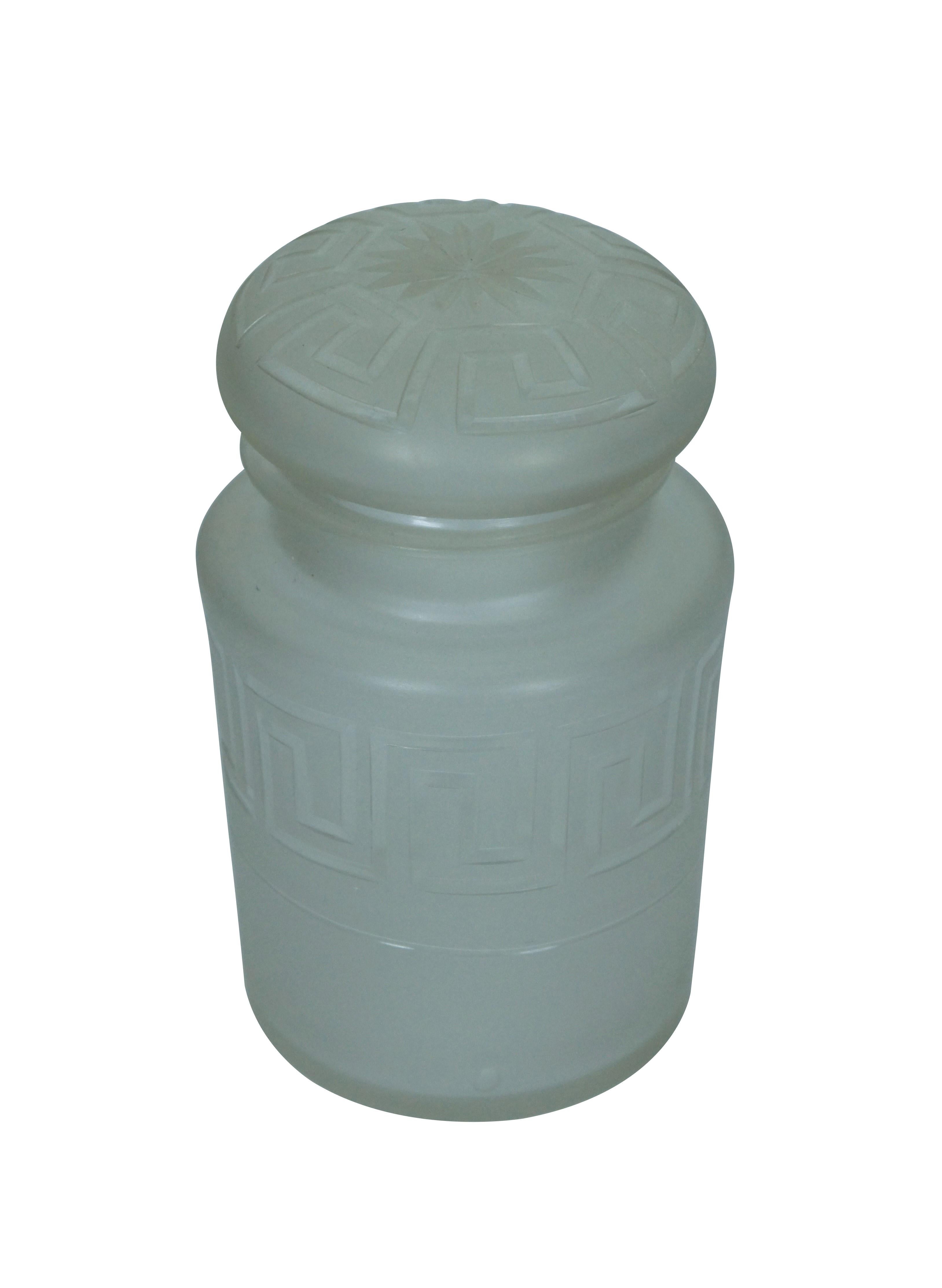 Circa early 20th century hand blown glass pickle or vanity jar with cylindrical body and mushroom shaped lid / stopper, frosted surface with a cut clear Greek key design around body and lid; polished pontil.

Dimensions:
3.5