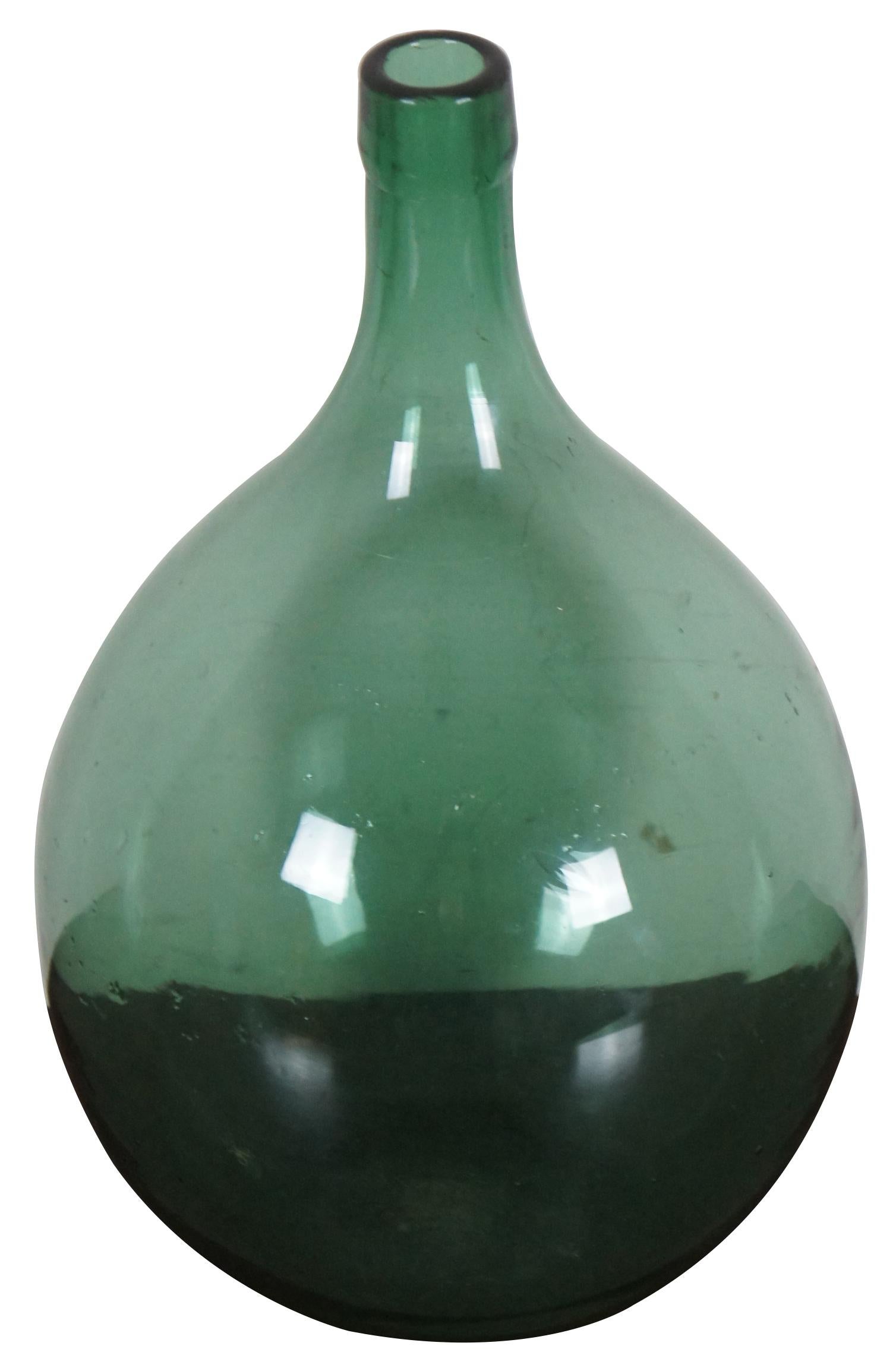 Antique hand blown French demijohn or bonbonne. Beautifully shaped and brightly colored green glass bottle with polished pontil bottom. Originally used for storing wine and spirits, demijohns were in wide use from the 1700s to the early 1900s.