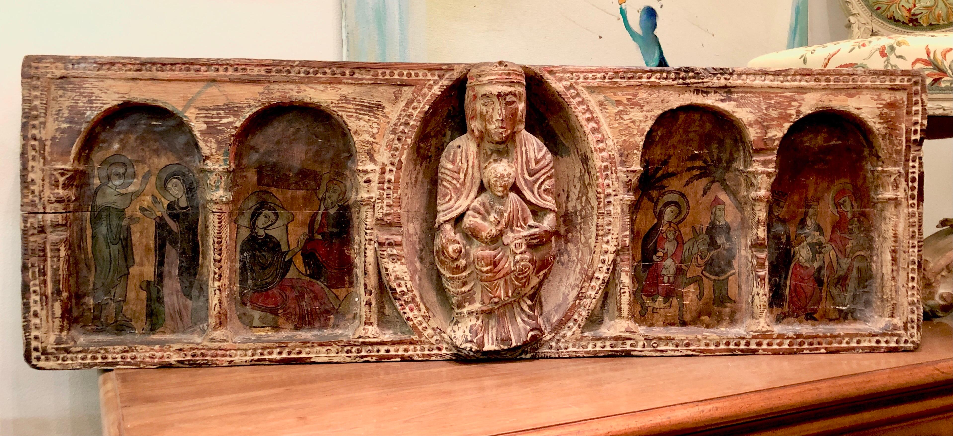 Antique piece of an altar hand carved of a single piece of wood. There is Virgin Mary holding Christ in the centre surrounded by four religions scenes.
France, circa 1900.
