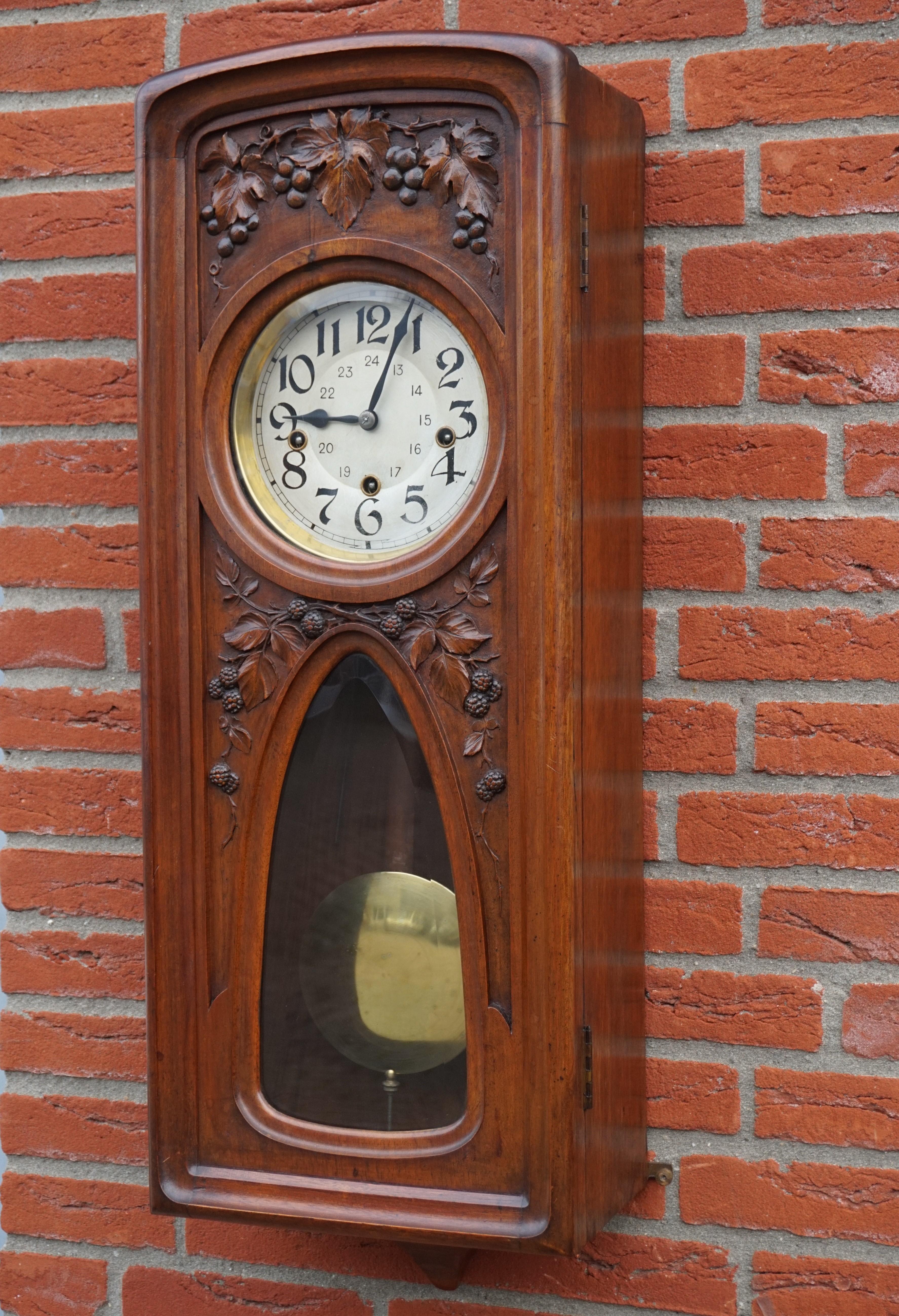 Stunning and perfect working antique wall clock, made of solid walnut.

Over the years we have sold a number of unique and beautiful wall clocks and this one of a kind specimen is right up there with the finest. The quality of the hand carved grape
