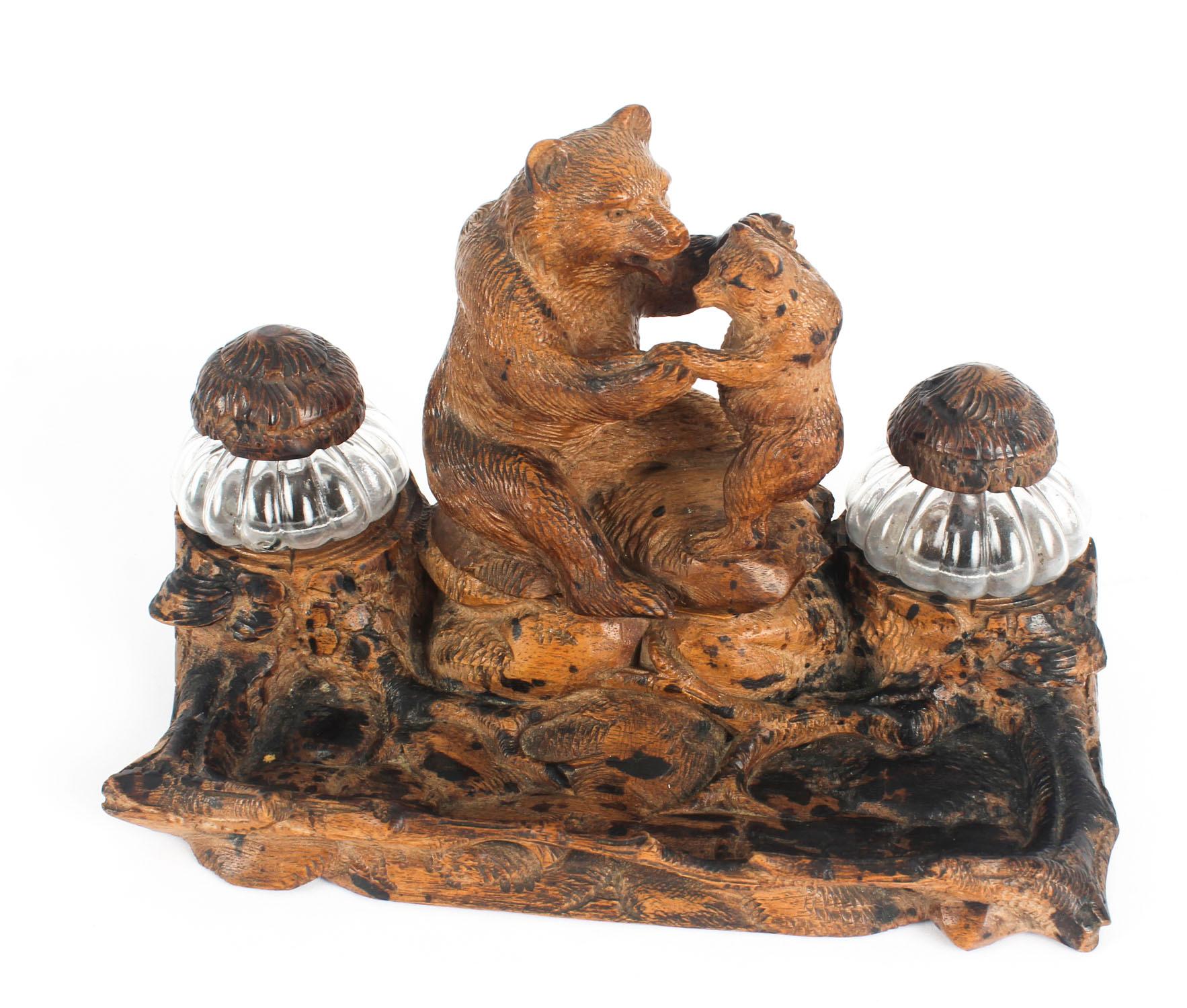This charming antique Black Forest inkstand dates from circa 1880.

Beautifully modelled, hand-carved from linden wood, with mother and baby bear on a naturalistically carved rocky outcrop. 

The inkwells are in the form of a pair of tree trunks