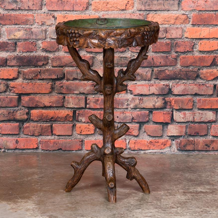 Black Forest items are always a wonderful find, including this unique plant Stand. Notice the base which has been hand carved to resemble a tree while the plant holder is circled with grape clusters and leaves. The metal center 