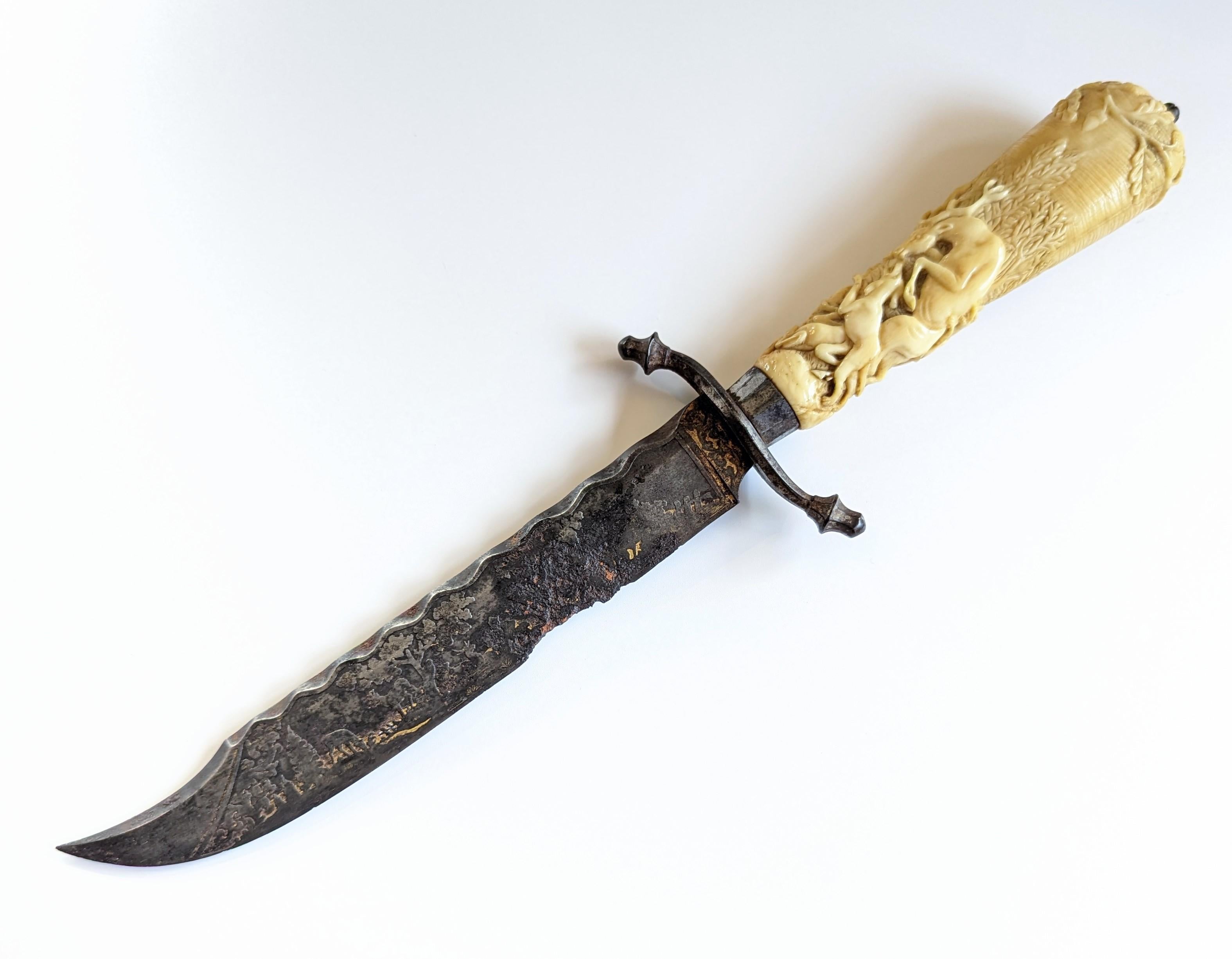 Exquisite antique hand carved bone knife with intricate hunting scene design. European made, possibly south German circa 1700s to 1800s, though we are not completely certain. The blade has hints of gilding along with an etched design on both sides.