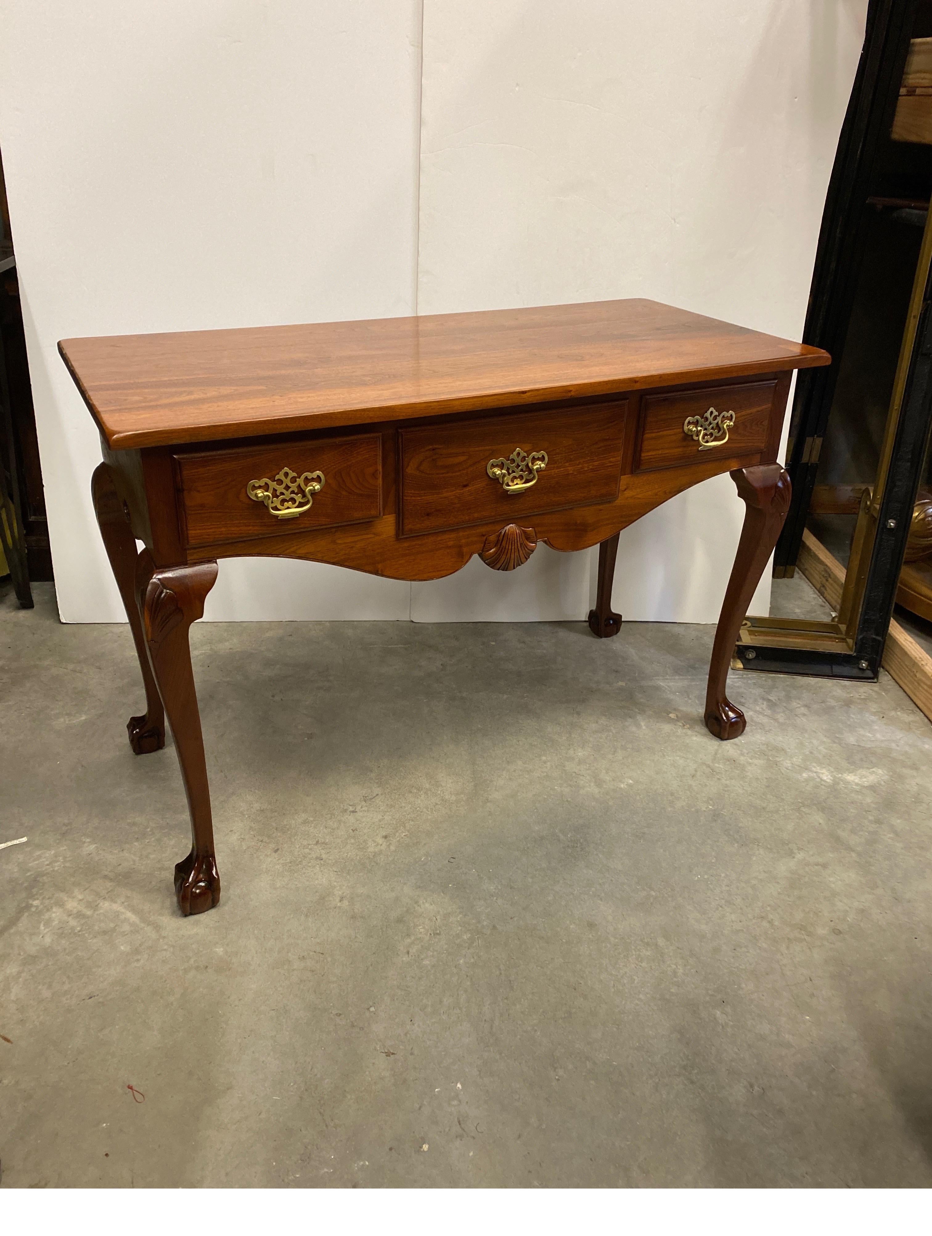 Elegant solid mahogany with had carved details. The solid top with natural figurative grain over three drawers with shell carving on the apron supported by four graceful cabriole legs ending on ball and claw feet. This piece has been thoroughly