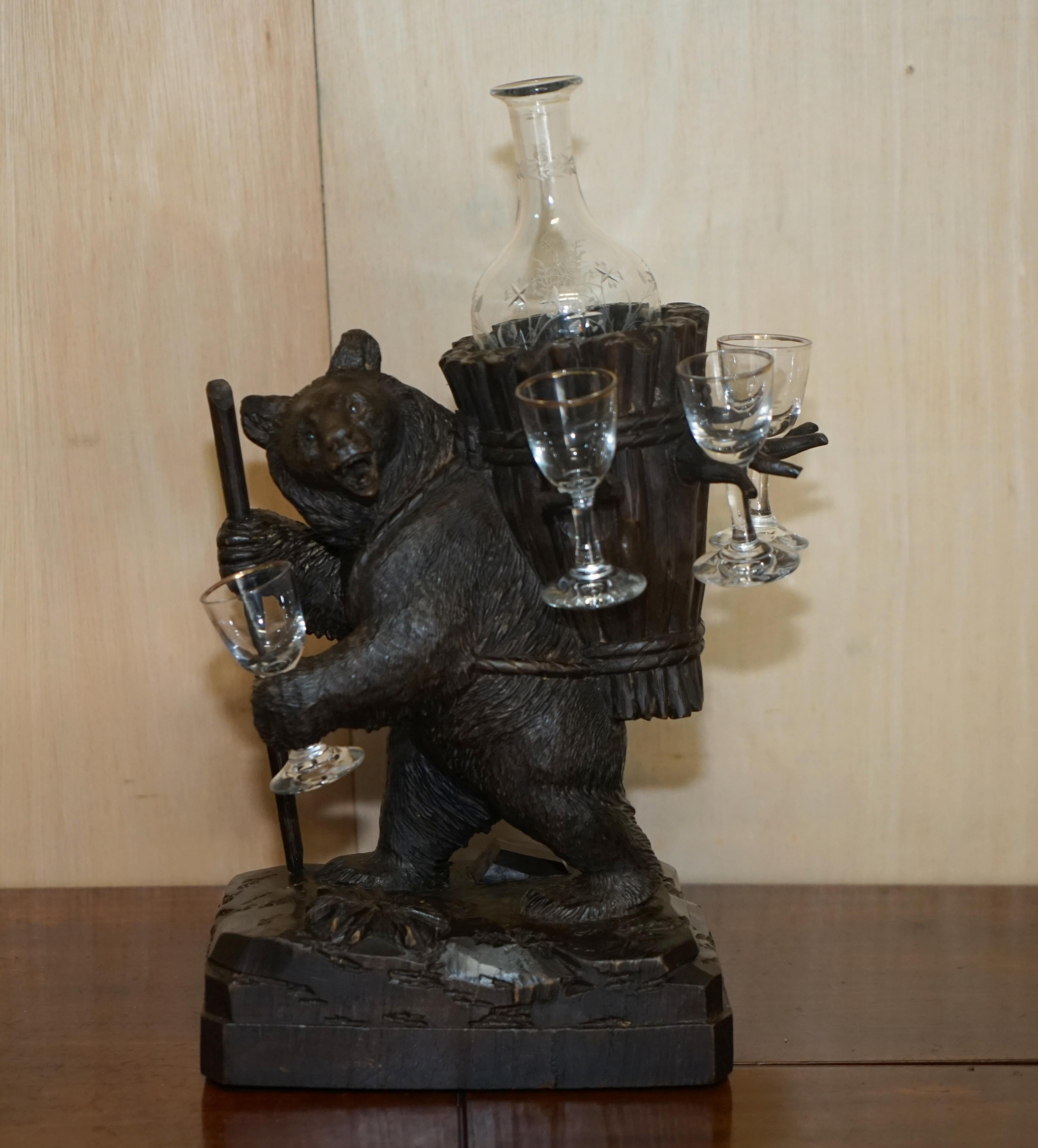 We are delighted to offer for sale this sublime original circa 1880 Black Forest Bear Musical drinks decanter 

A good looking and decorative piece, it is hand carved from black forest wood which is a very dark timber as the trees are all very