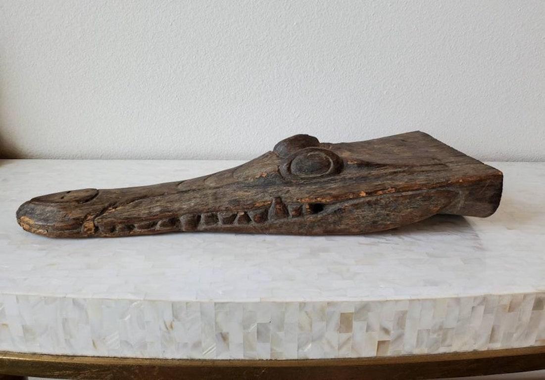 A remarkable hand carved wooden crocodile canoe prow figure, collected from the Central Sepik River region of Papua, New Guinea, Oceania, dating to the late 19th / early 20th century, likely Iatmul peoples.

The exceptionally executed Indonesian