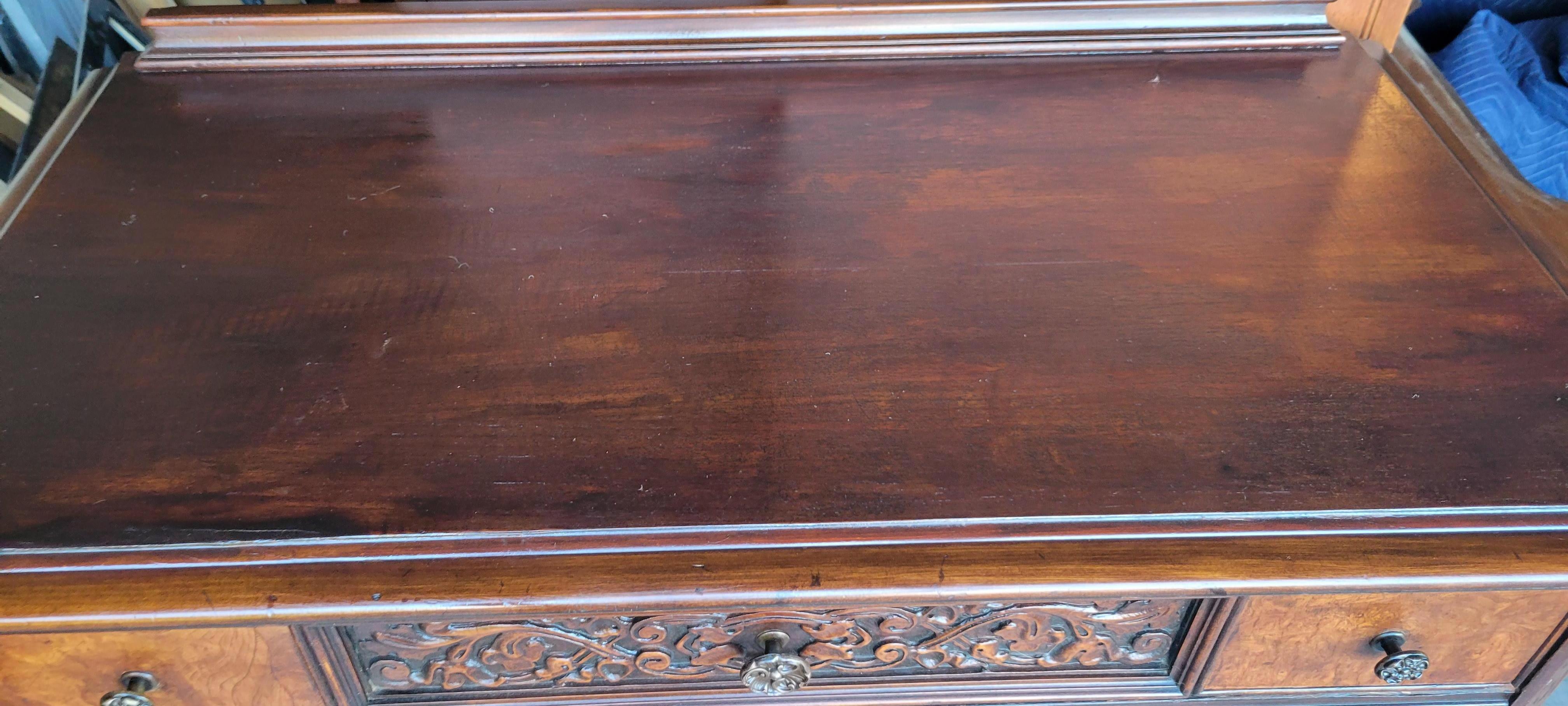 Antique carved walnut - mahogany dresser: 51 inches tall, 38 inches wide and about 19 inches deep. The dresser has 5 drawers, all with the original hardware. 
The dresser is constructed with solid wood and decorated with veneer. 
The drawers have