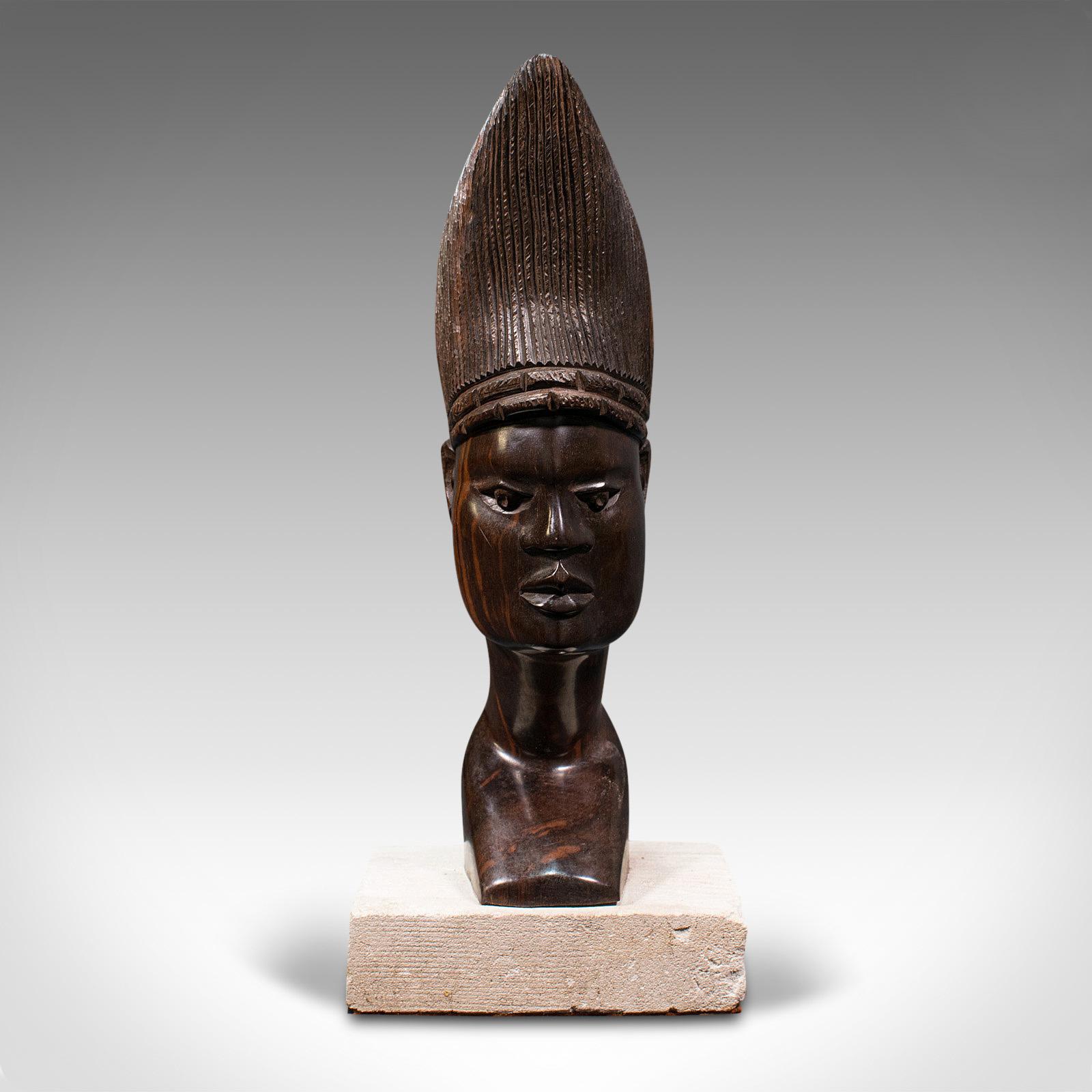 This is an antique hand-carved female bust. An African, ebony ornamental figure on Portland stone base, dating to the late 19th century, circa 1900.

Striking form with an inherent beauty
Displaying a desirable aged patina
Hand-carved ebony with