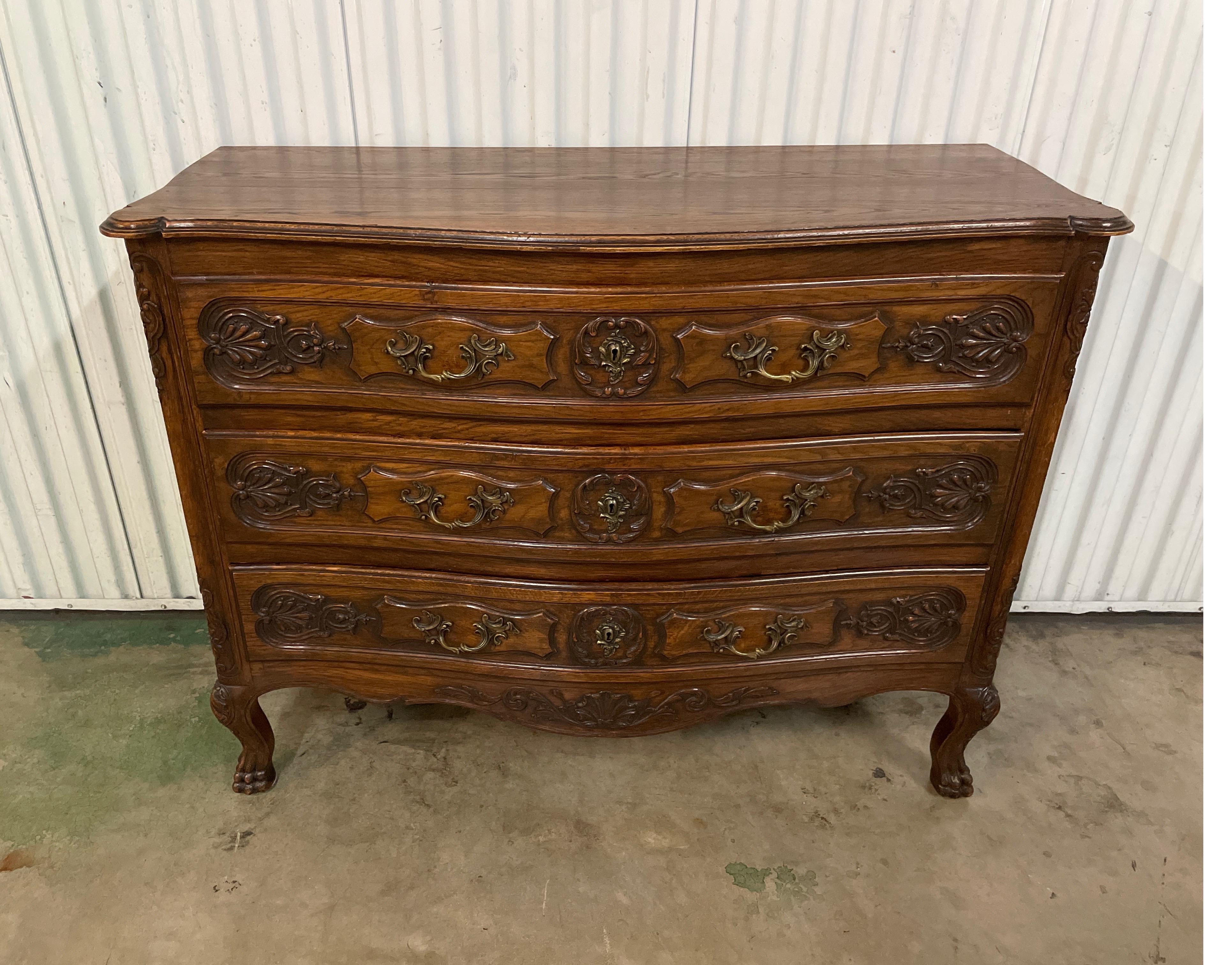 Country French hand carved three drawer dresser with paw feet.