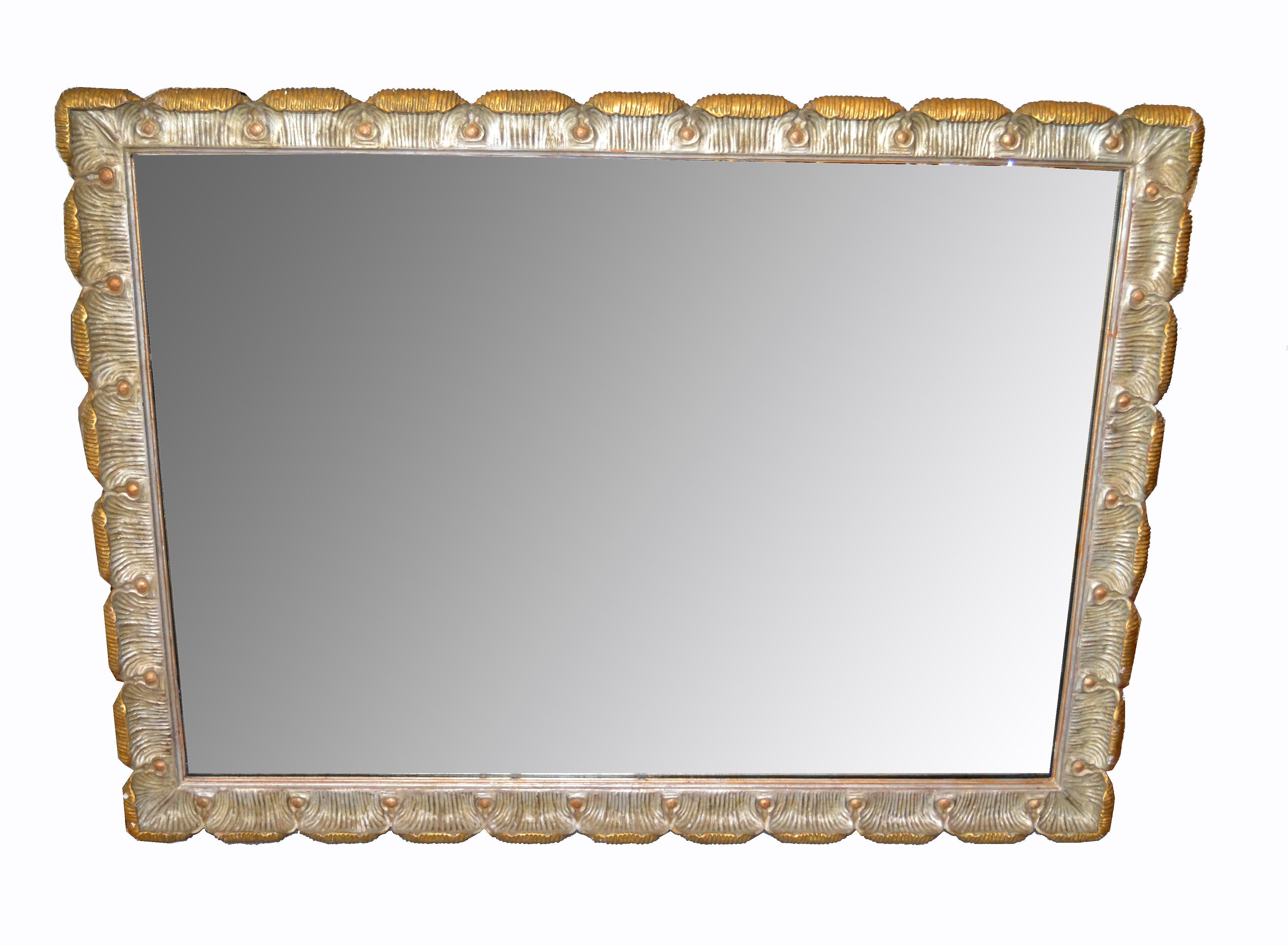 Italian antique golden hand carved rectangular wall mirror from Florence.
This mirror is made out of scalloped carved wood and is very heavy.
It can be hung horizontal as well as vertical.
Mirror size: 33.5 x 48 inches.
 
