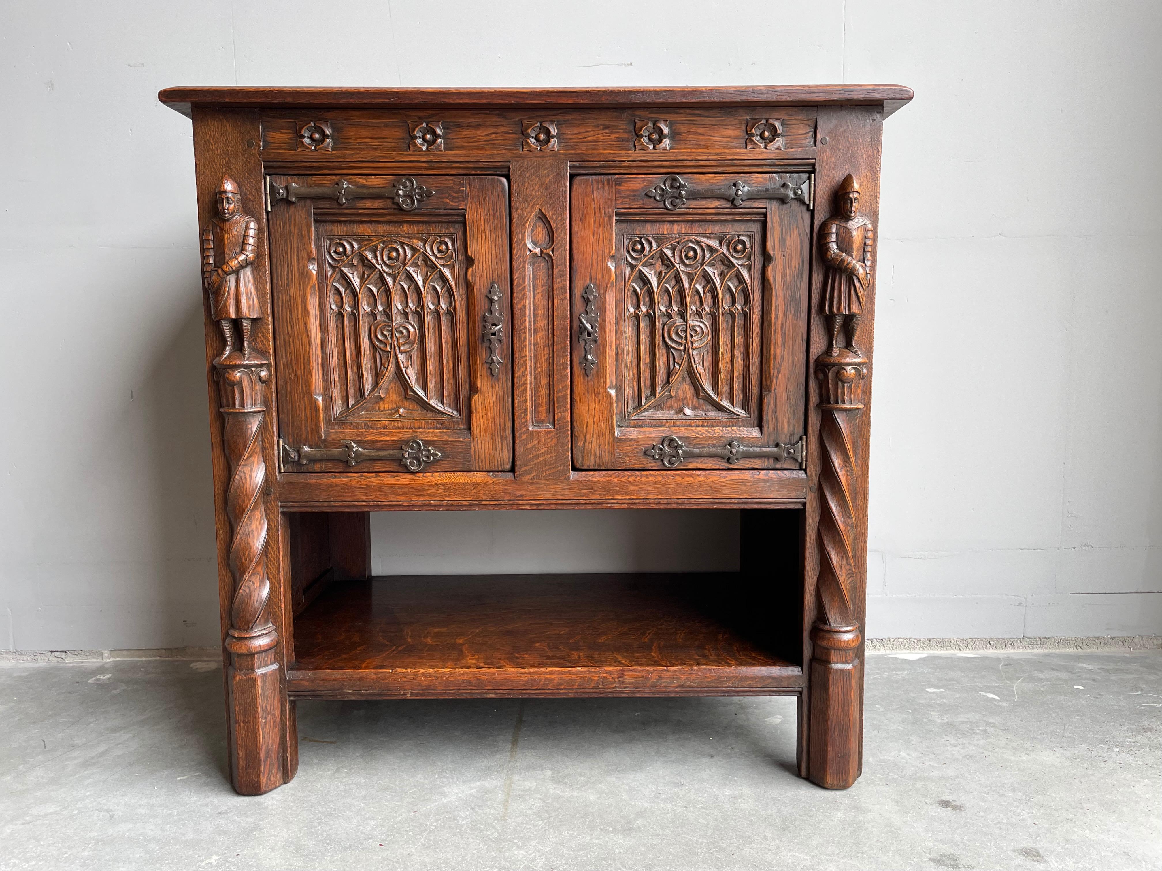 Marvelous and practical Gothic Revival cabinet with Medieval knight sculptures and great patina.

This rare, Dutch workmanship Gothic dry bar truly is in excellent condition. This beautifully hand carved cabinet comes with two knights who are like