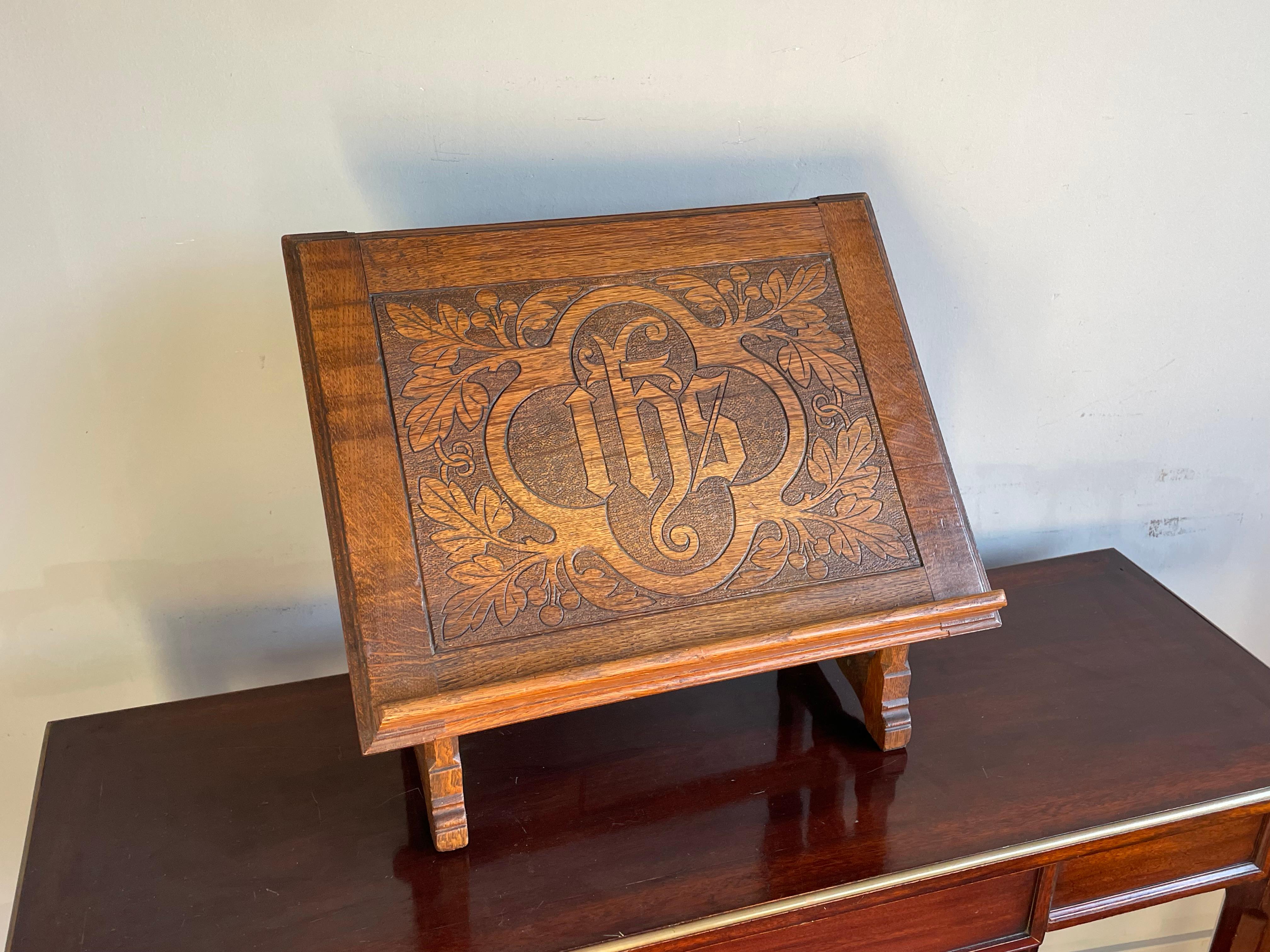 Good size, antique bible stand with stylized IHS symbol in Gothic quatrefoil.

This beautifully and richly hand-carved Gothic bible stand dates from circa 1890-1910 and it is entirely made of solid (tiger) oak. This rare church relic is in great