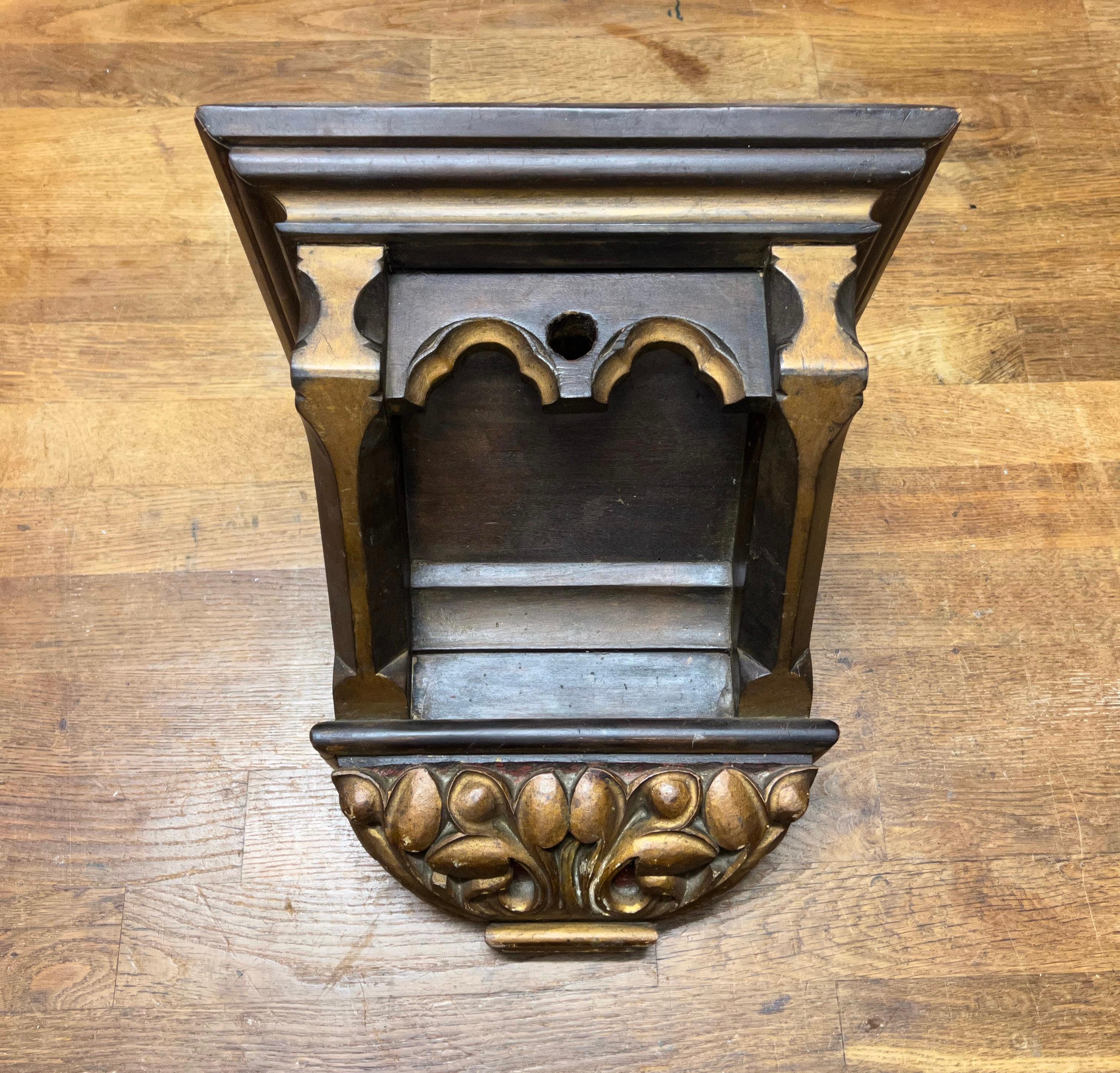 Good size, partially gilt and great looking Gothic Revival bracket for displaying a Saint statue.

This Gothic console for wall mounting dates from the late 1800s and it has a marvelous combination of Gothic elements that make it a joy to own, to