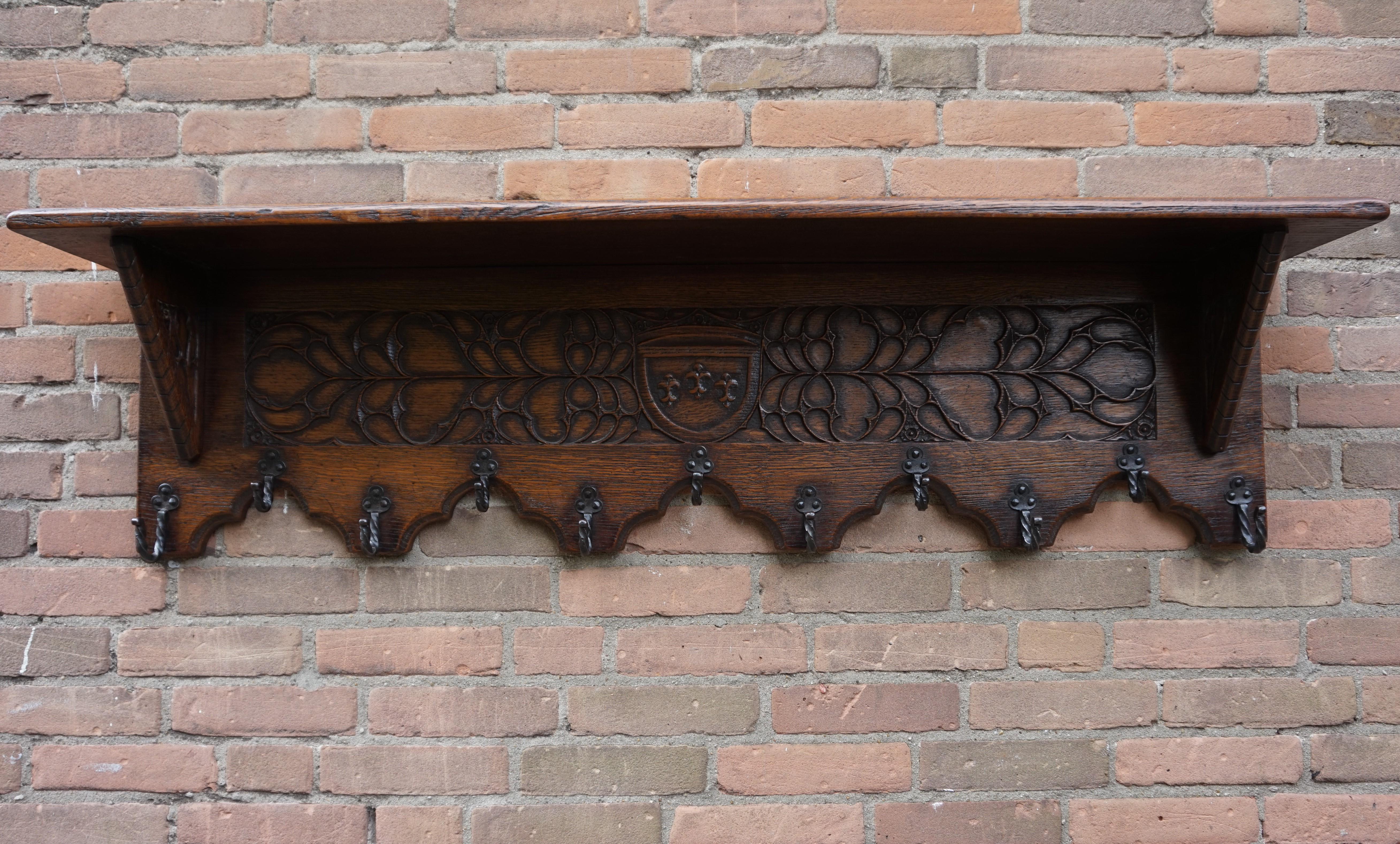 Wonderful craftsmanship, solid oak Gothic Revival wall coat rack.

Anyone who has ever visited a Gothic (Revival) church or another Gothic style building will immediately recognize the same stunning elements in this wall coatrack. The symmetry in