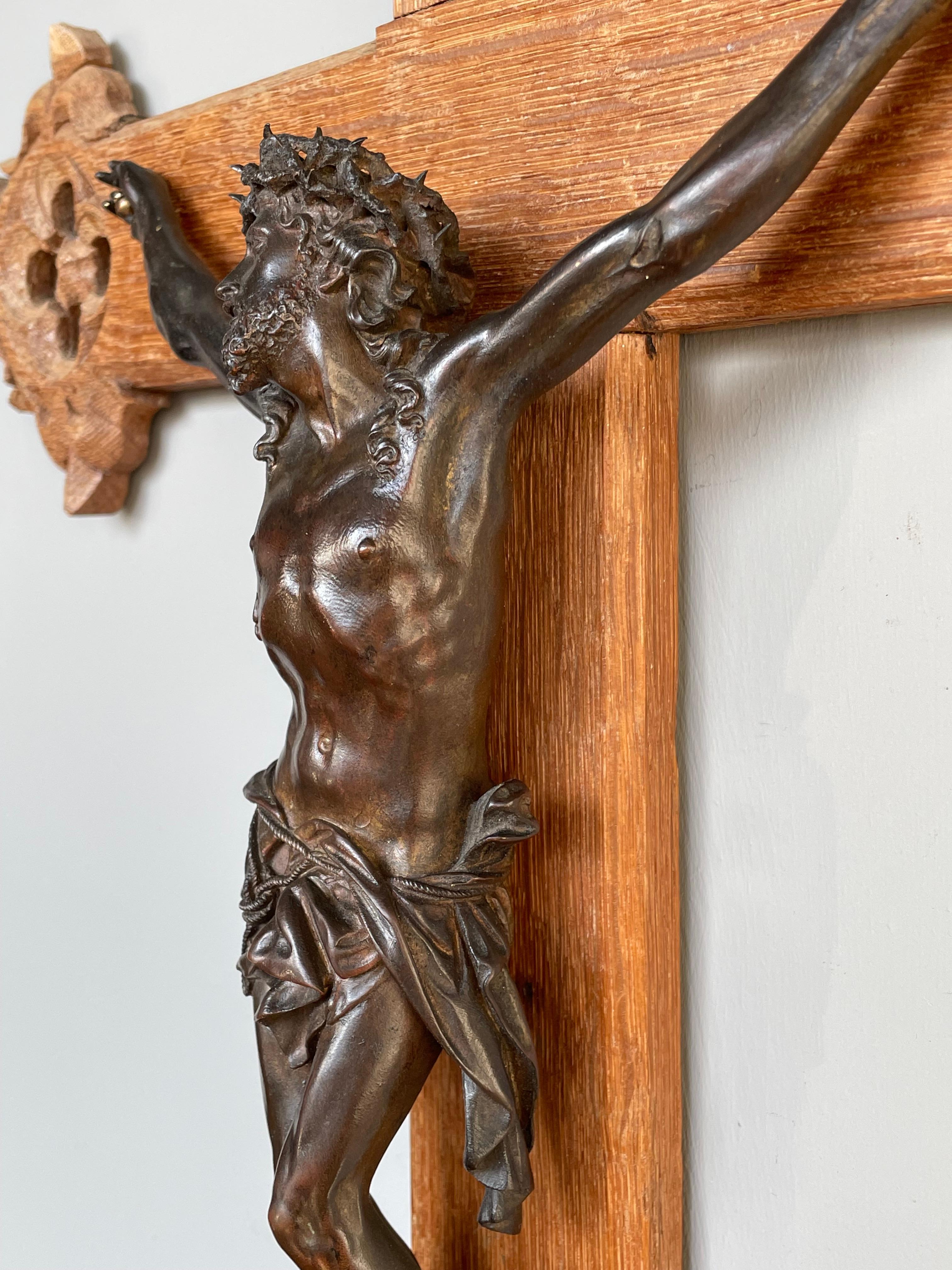 Gothic style church crucifix with an incredibly detailed bronze corpus of Christ.

What makes this stylish crucifix extra rare are the Gothic elements that are hand carved on all ends of the cross. This medieval style combined with the fact that