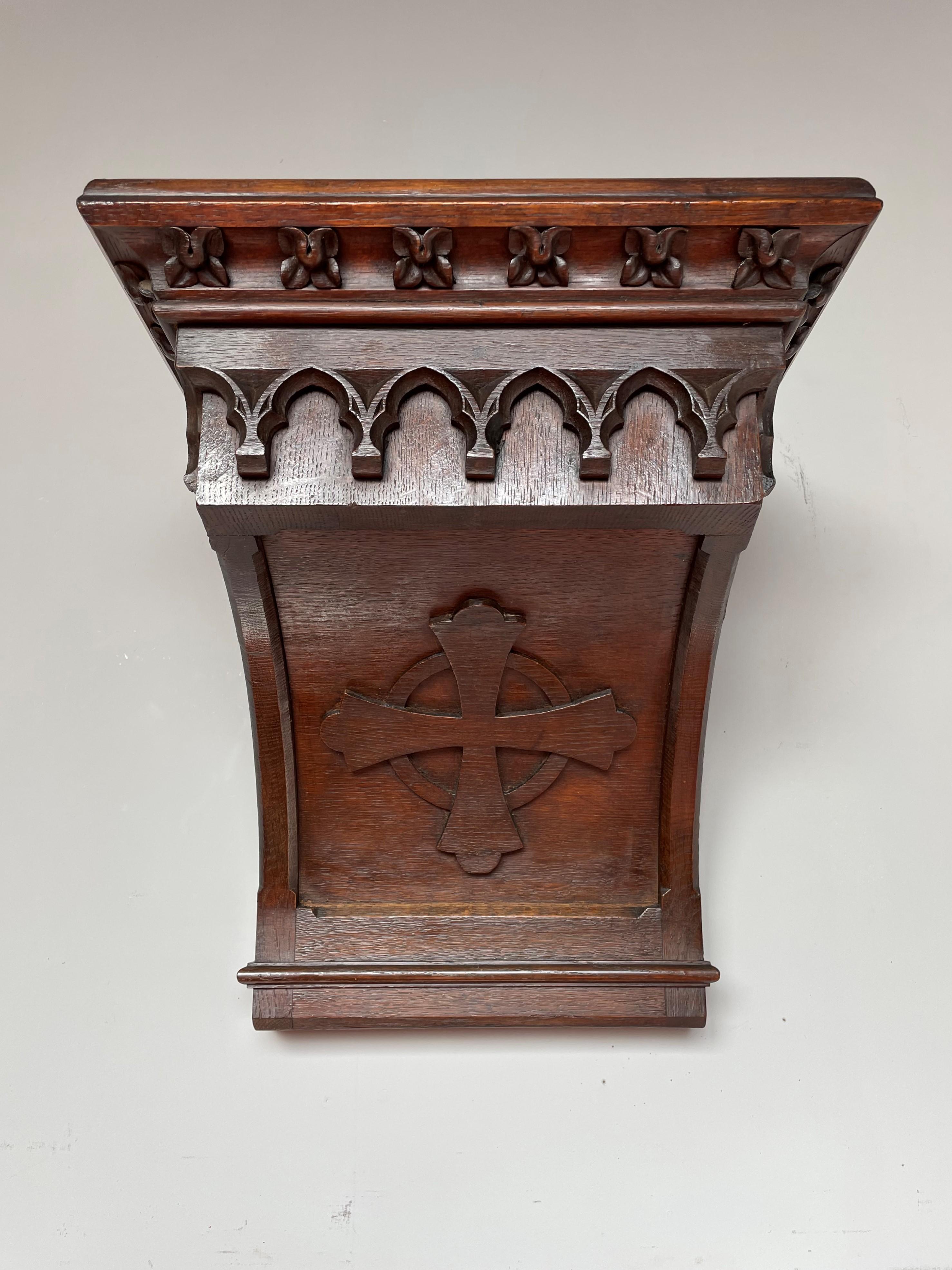 Good size and great looking Gothic Revival bracket for displaying a saint statuette.

This Gothic console for wall mounting dates from the late 1800s and it has the most beautiful design and patina. In the arch below the top is a Medieval cross