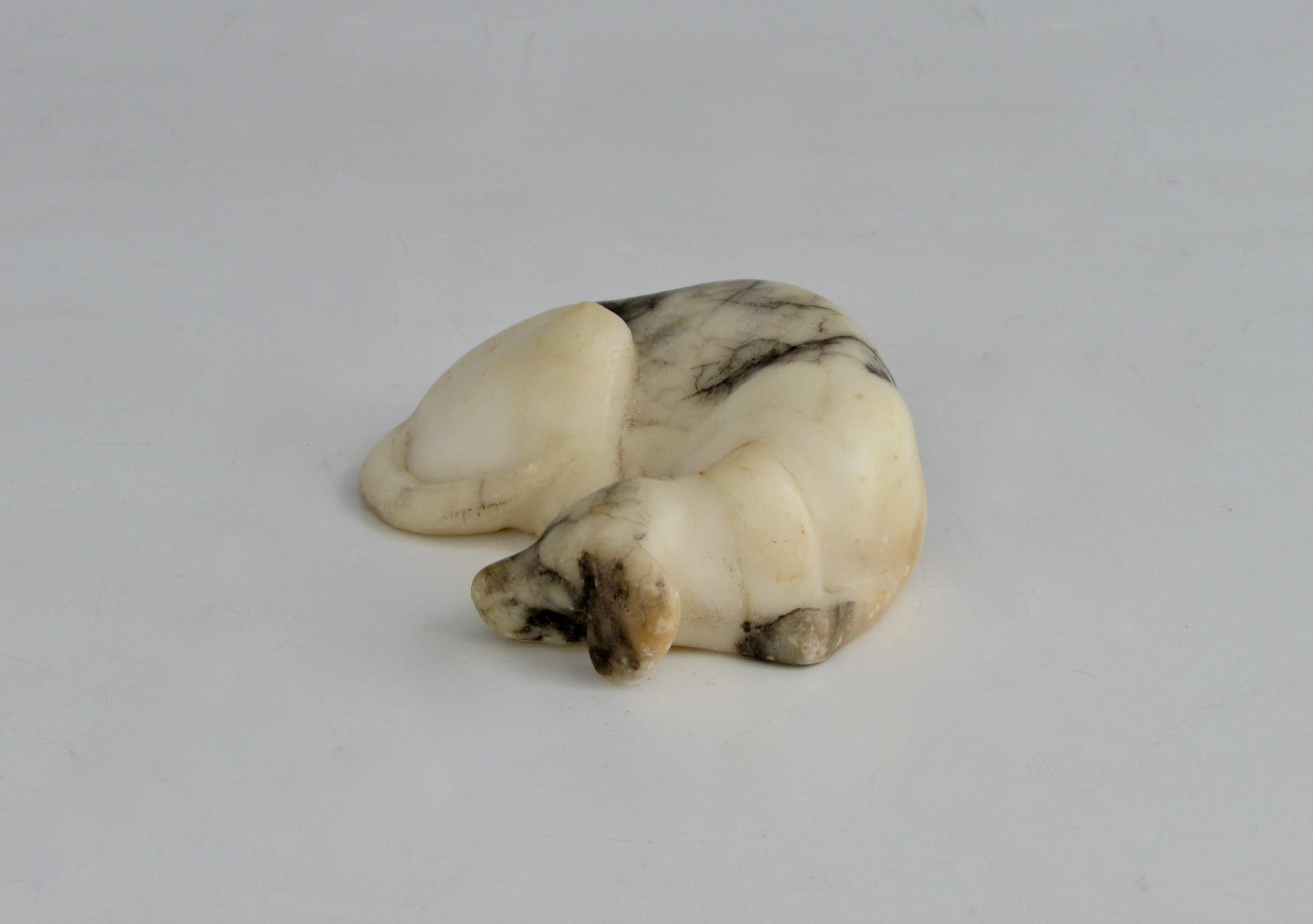 A hand carved marble sleeping dog. Signed Made in Italy, Mrs. R. Hoebel. 

We love color striations in the marble, face and ears.