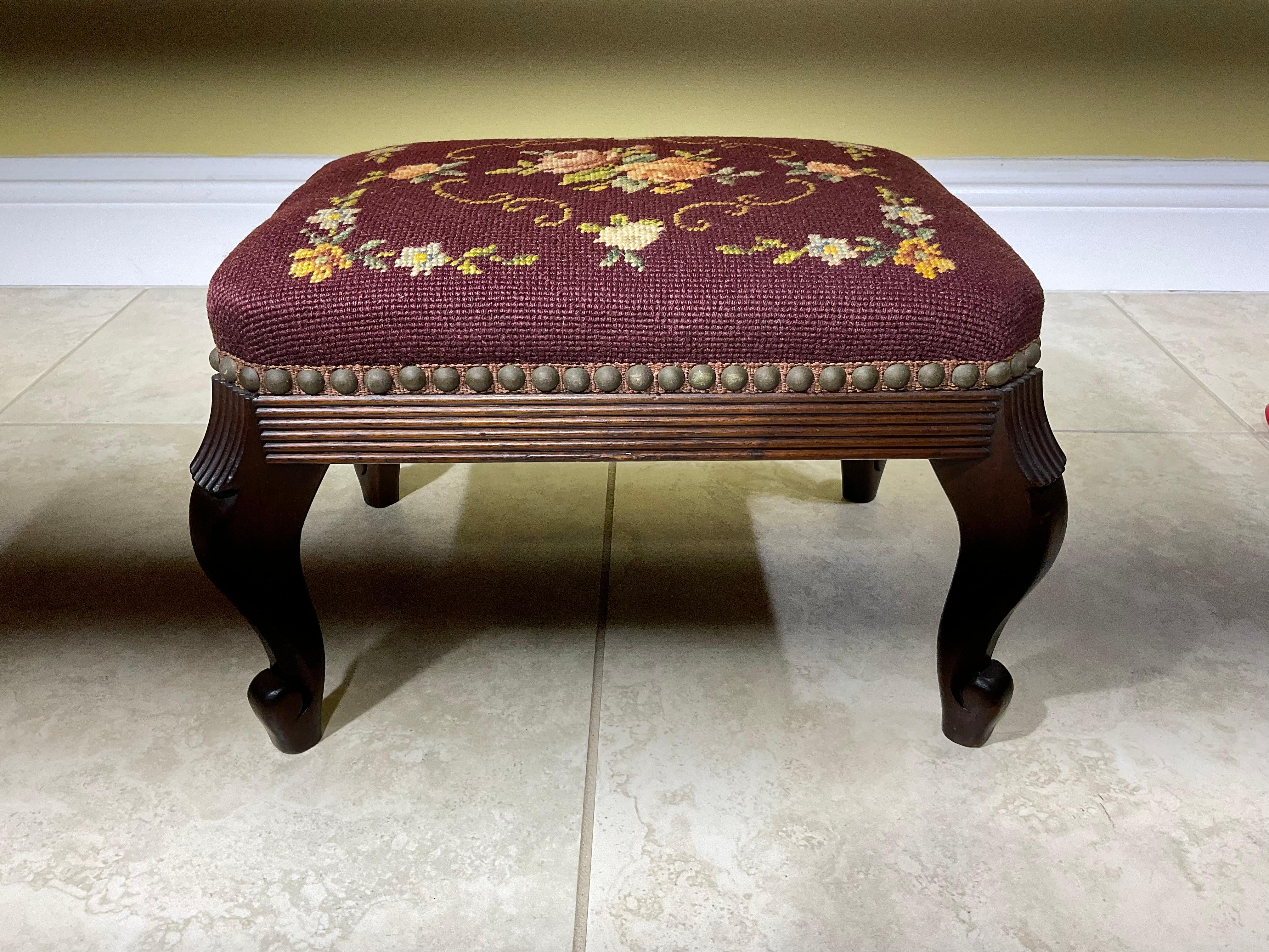 Petite Elegant foot stool made hand carved woof wood, upholstered with beautiful floral motif needlepoint textile.
Great decorative object of art for any room.