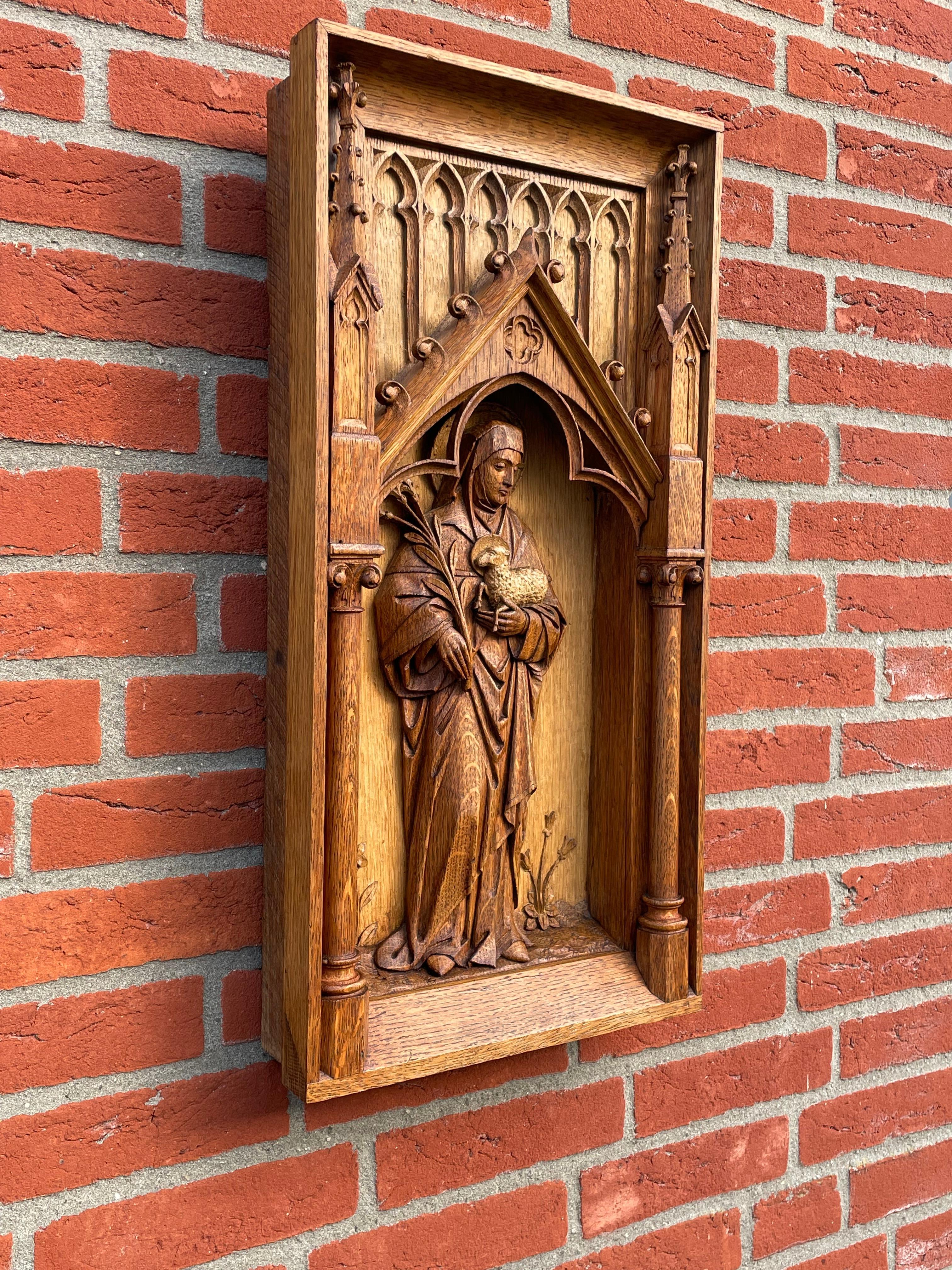 Rare, finest quality and great condition religious wall panel in deep carved relief.

This striking, hand carved, symbolical wall panel depicting Saint Agnes holding the lamb in her left and palm leafs in her right hand probably came out of a church