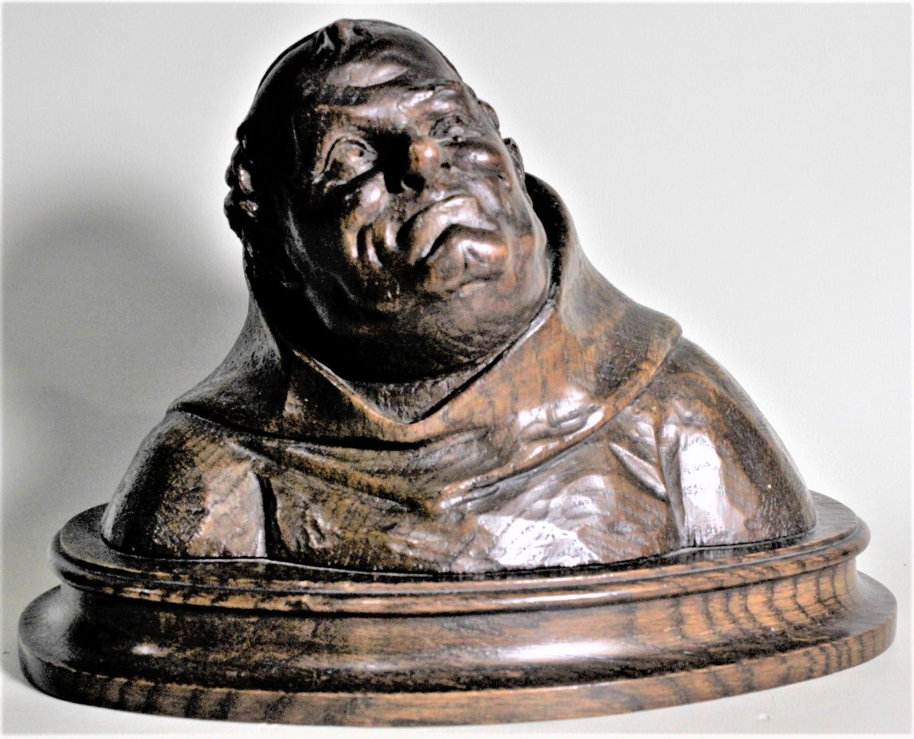 This well executed hand carved bust is unsigned, but believed to have been done in England in circa 1900 in the period Edwardian style. The sculpture is composed of solid oak and depicts a chubby monk with his head tilted slightly and looking