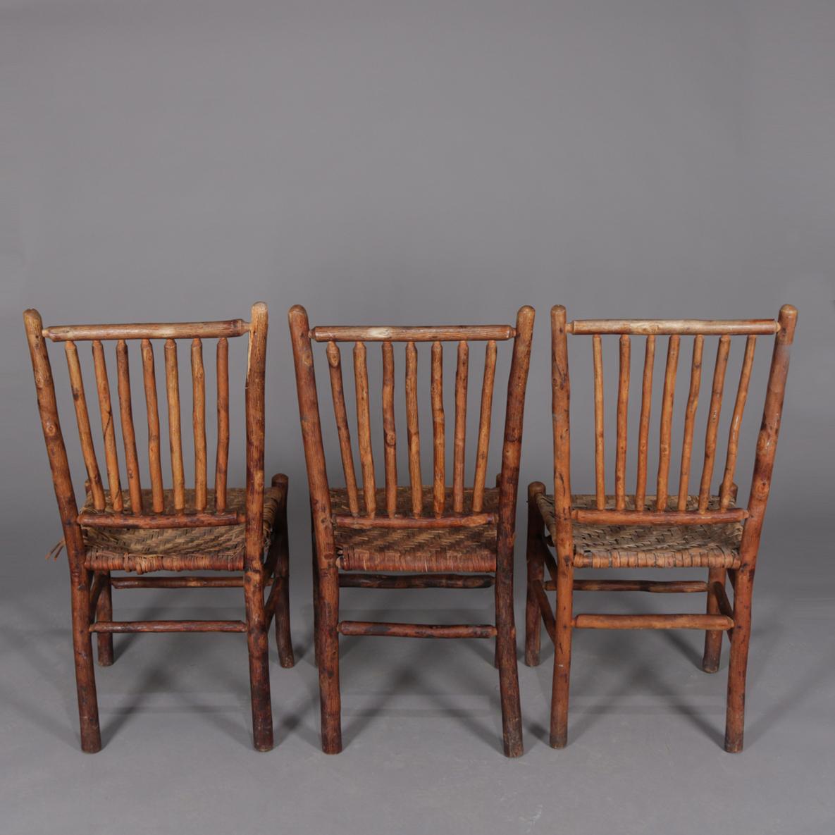 Antique hand carved Adirondack side chairs by Old Hickory features branch form frames with rush seats, signed, circa 1900.

Measures: 38.5