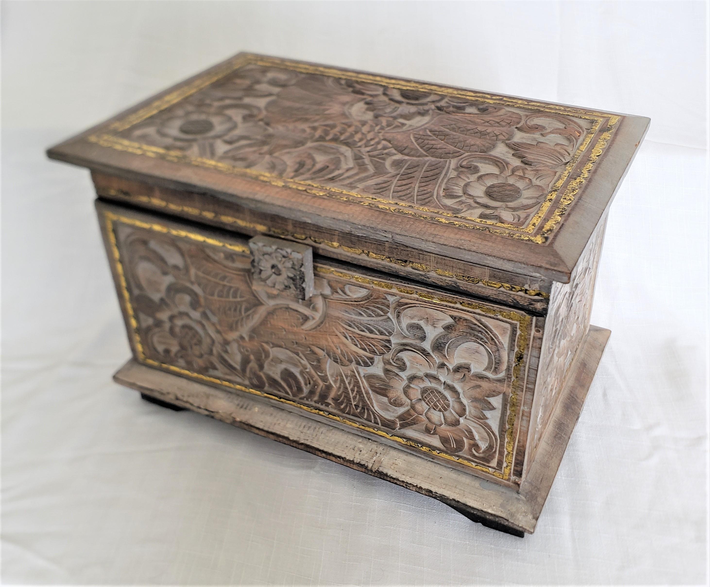 This large antique hand-carved and hand-painted box bears no maker's signature, but presumed to have originated from the Netherlands and dating to approximately 1920 and done in a Folk Art or Boho style. The box is composed of a softwood that has