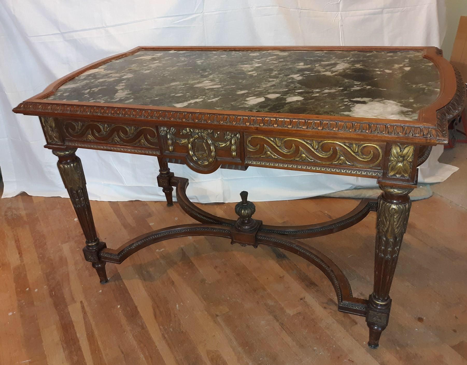 A 19th century carved walnut table with marble top. The dark green and white original marble inset top with expertly carved edge, on the apron and on the legs. The top is affixed to the base.