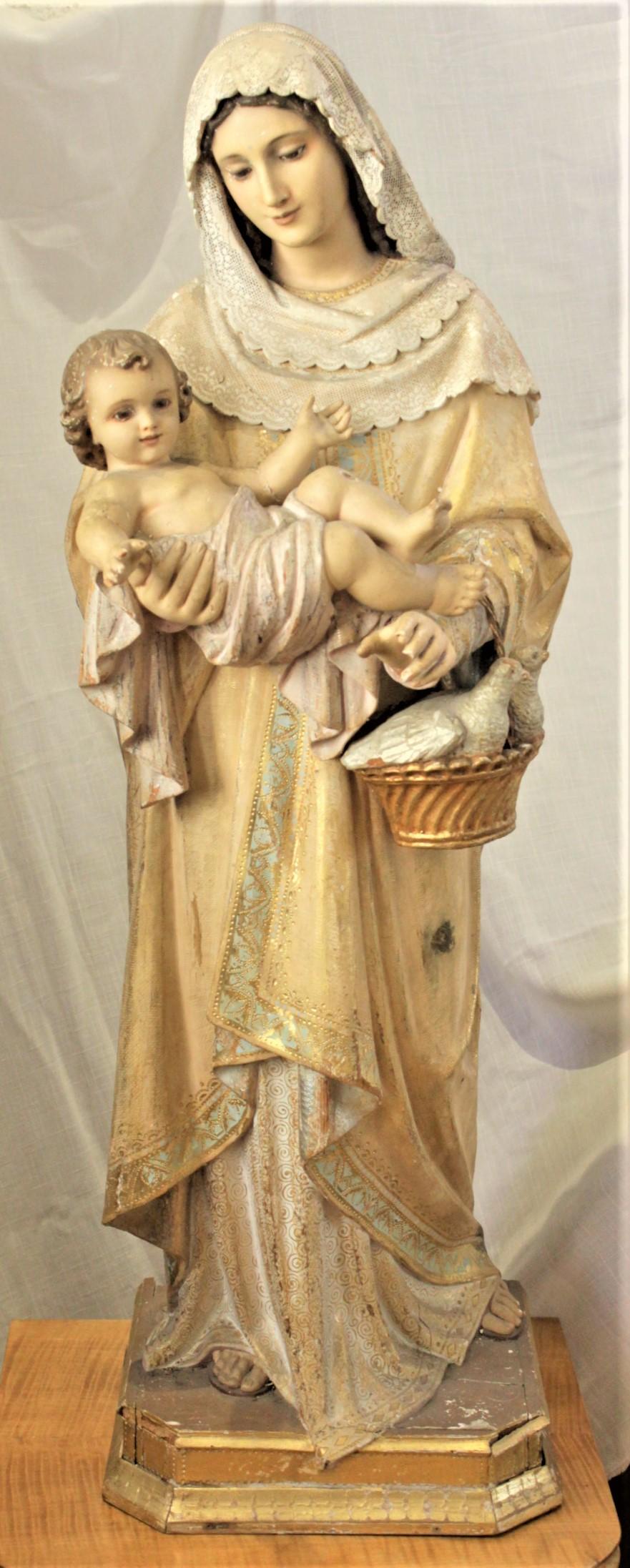 This well executed hand carved wooden sculpture of the Madonna and Child is unsigned, but presumed to have been done in Europe, likely Italy or England, in approximately 1900 in the period Edwardian style. The sculpture is composed of pine and is