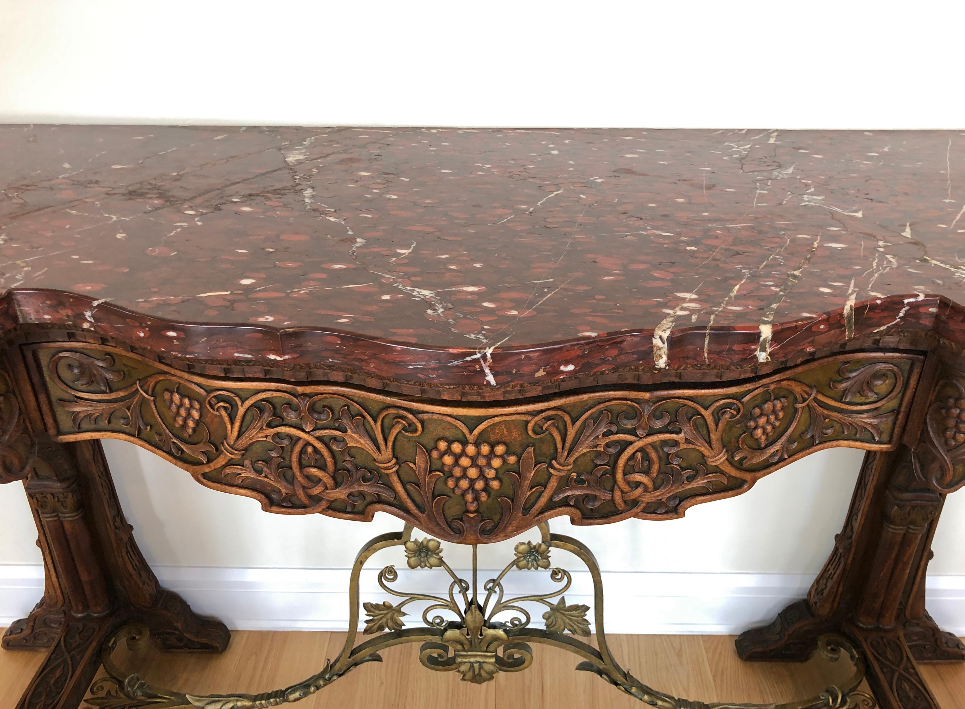 Impressive antique hand carved red marble top server table. American hand carved and hand wrought bronze marble top Gothic revival sideboard server with tree draws. With elements of Gothic and Renaissance Revival, this piece has both an impressive