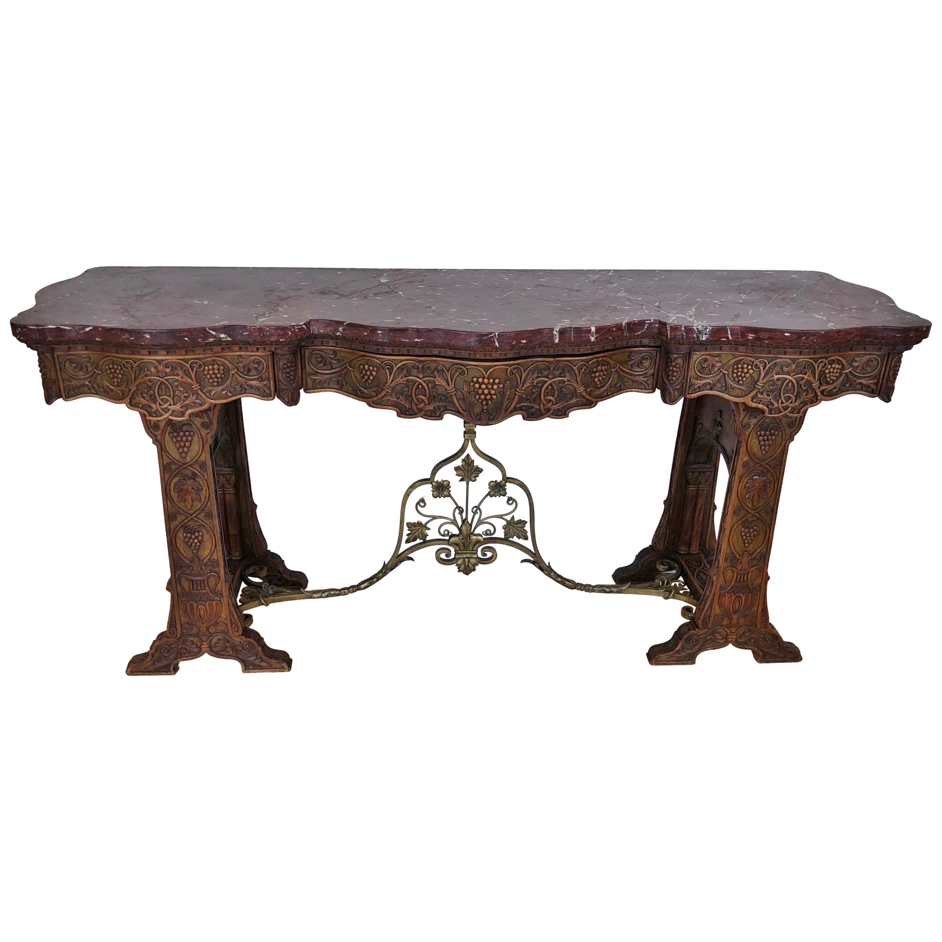 Table console en fer sculpté et doré à plateau de marbre rouge