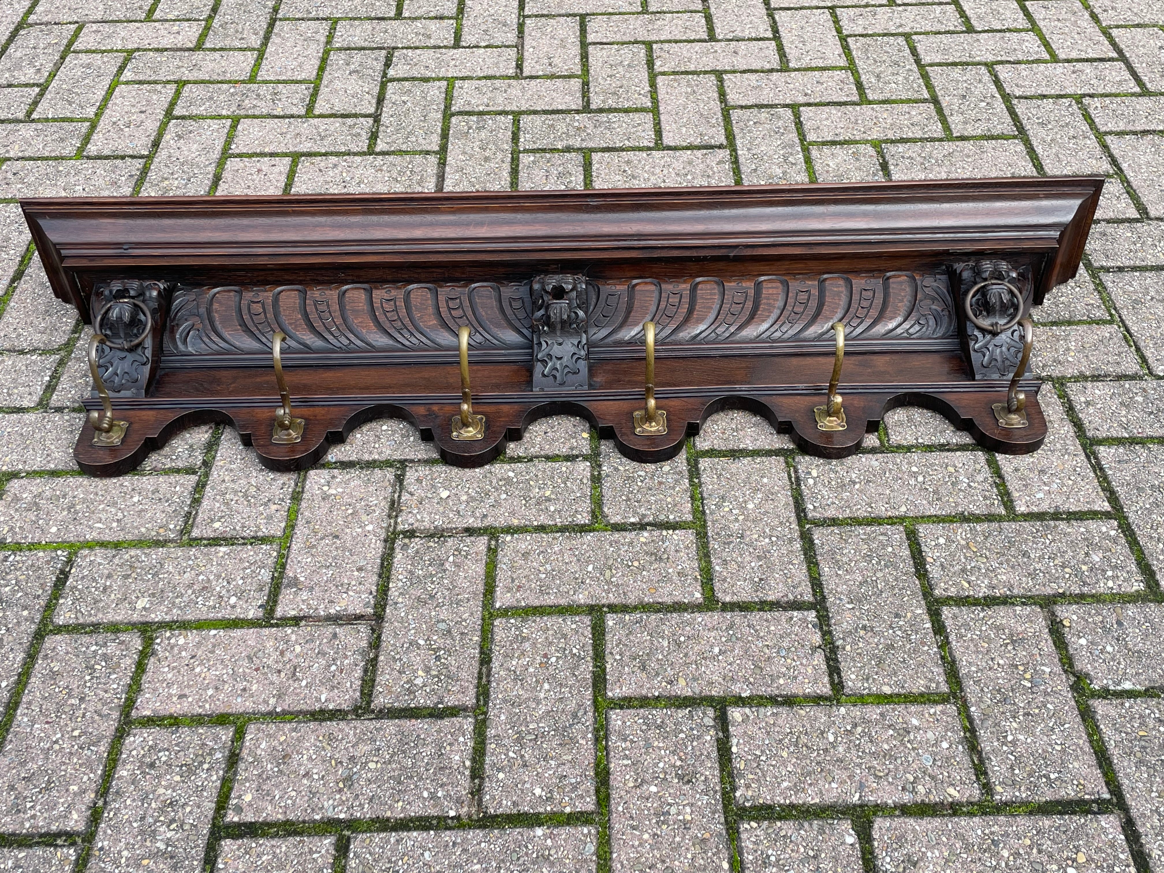 Sizable and beautifully sculptural oak wall coat rack with perfect brass hooks, circa 1900.

This striking antique Dutch coat rack is special, practical and highly decorative. It is special, because of the quality of the Renaissance carvings and its