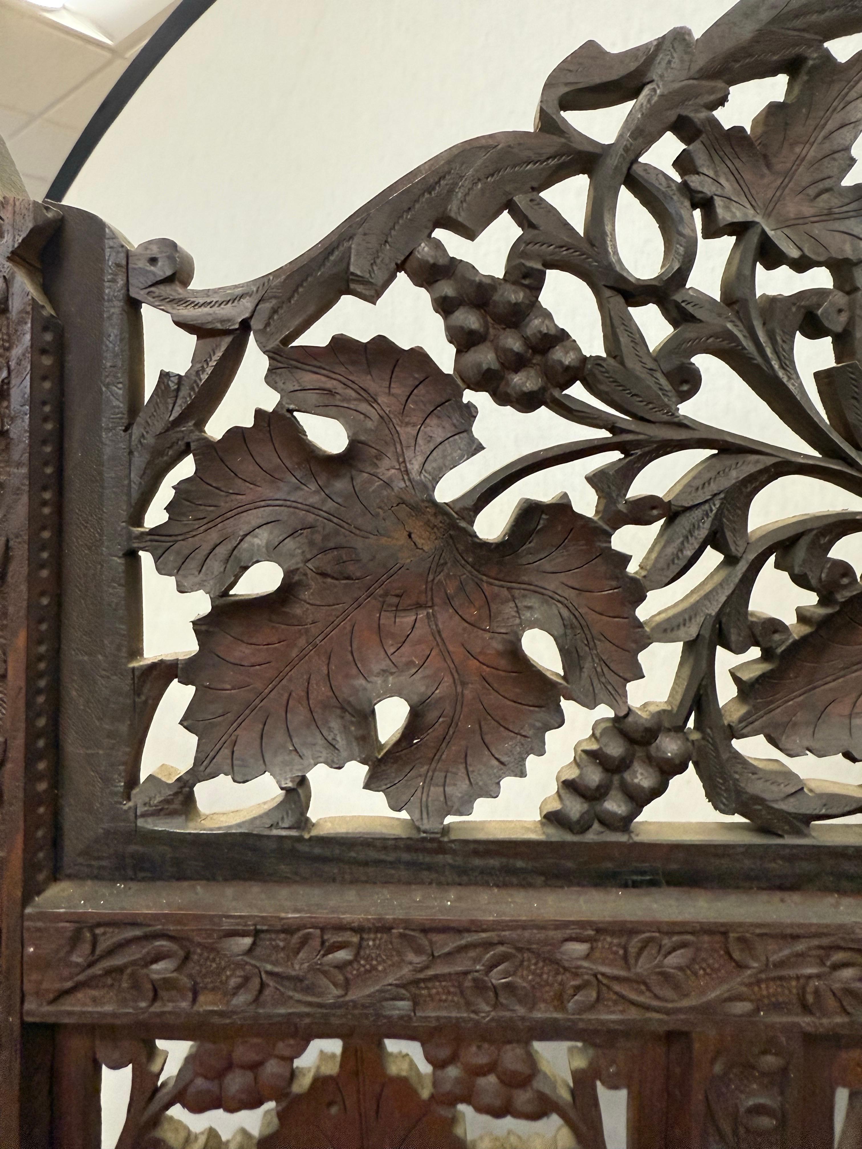 Elegant handcrafted with remarkable skill, each panel featuring detailed openwork floral and foliate motifs highlighting the rich warm grain of the dark teak wood.  Perfect as a chic room divider or a statement piece.  We have had clients mount
