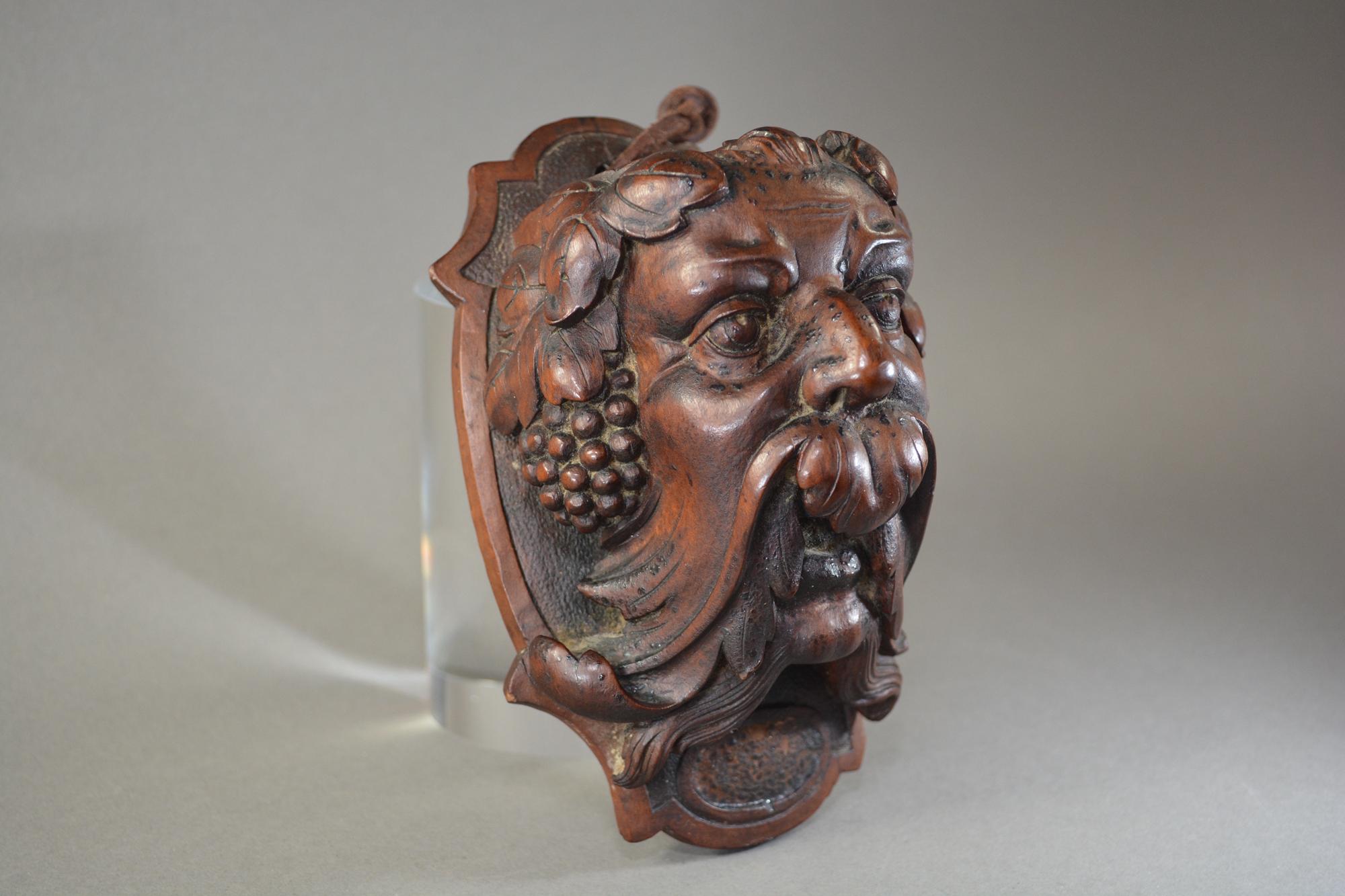 Antique hand carved walnut Bacchus head wall pocket European, circa 1860. Measures: 15.5cms tall, 9cms wide and 8.2cms deep. 6 1/8 inches tall, 3 1/2 inches wide and 3 1/4 inches deep.