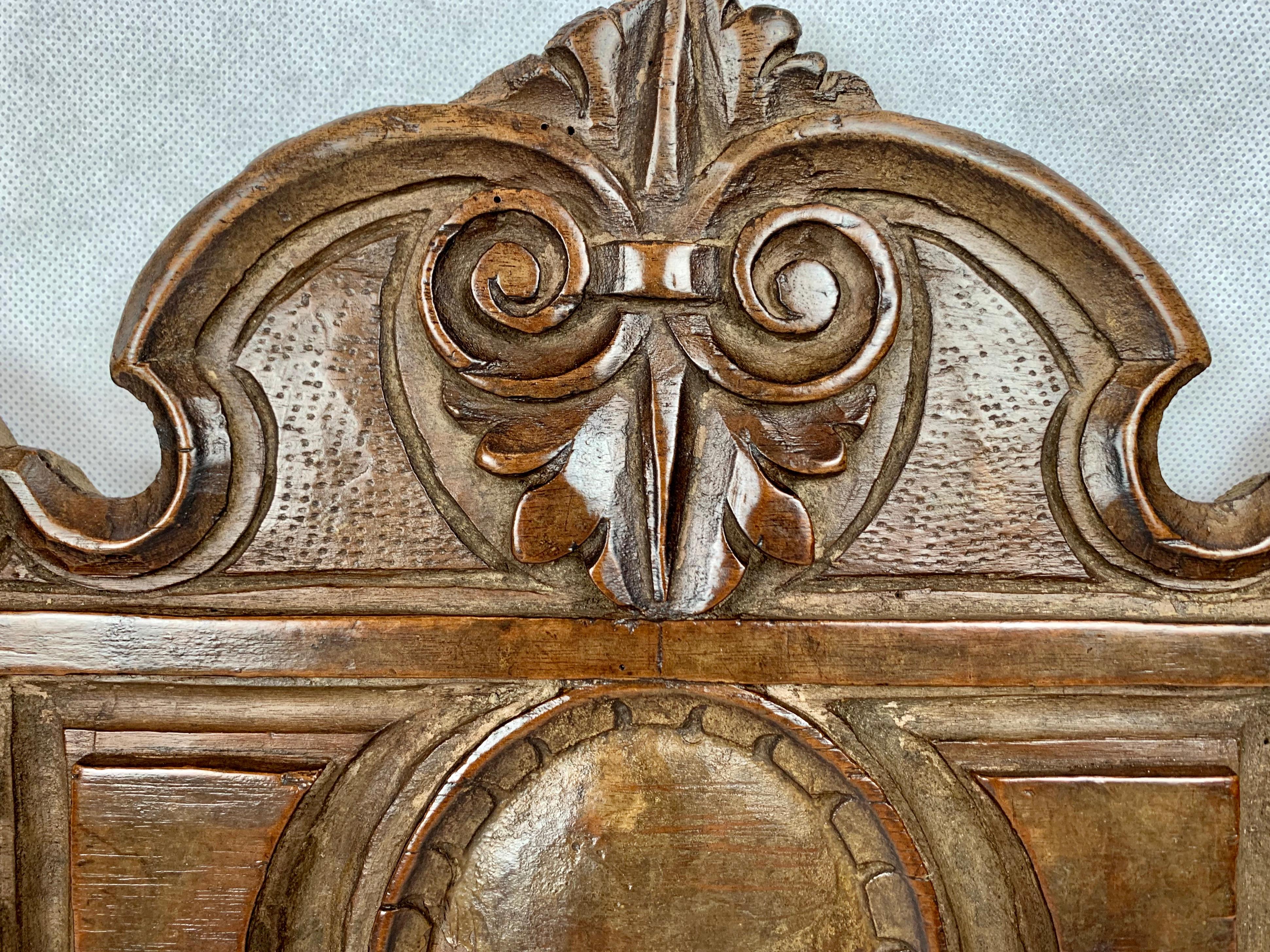 Antique hand carved walnut panel. Interesting scrolls and leaves atop a raised panel enclosing a convex oval. The side motif is again of scrolls topping a floret. If you look closely you can see the obvious differences of hand carving. Some of the
