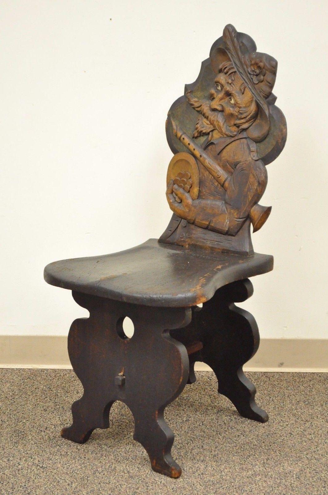 Antique European hand-carved Medieval Musician Tavern Chair. Item features remarkable solid carved wood figural frame, shaped seat, unique construction, and beautiful aged patina, circa believed to be late 19th century, Europe. Measurements: 39.5
