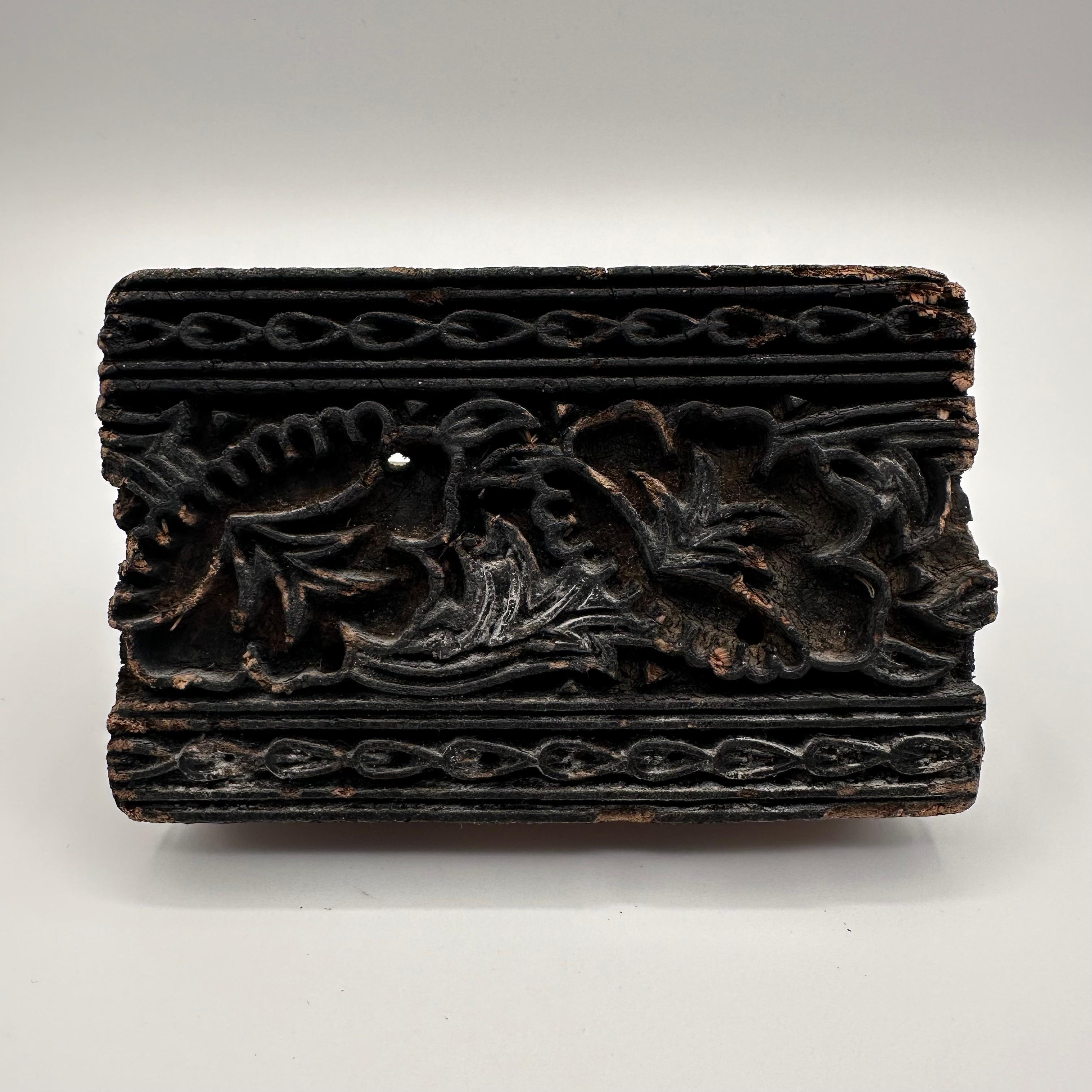 Amazing antique expertly hand-carved wood block that has been used in printing production. Stained dark black with ink, this now rustic piece shows signs of years of handling, while still being stunningly beautiful as a textural, sculptural object.