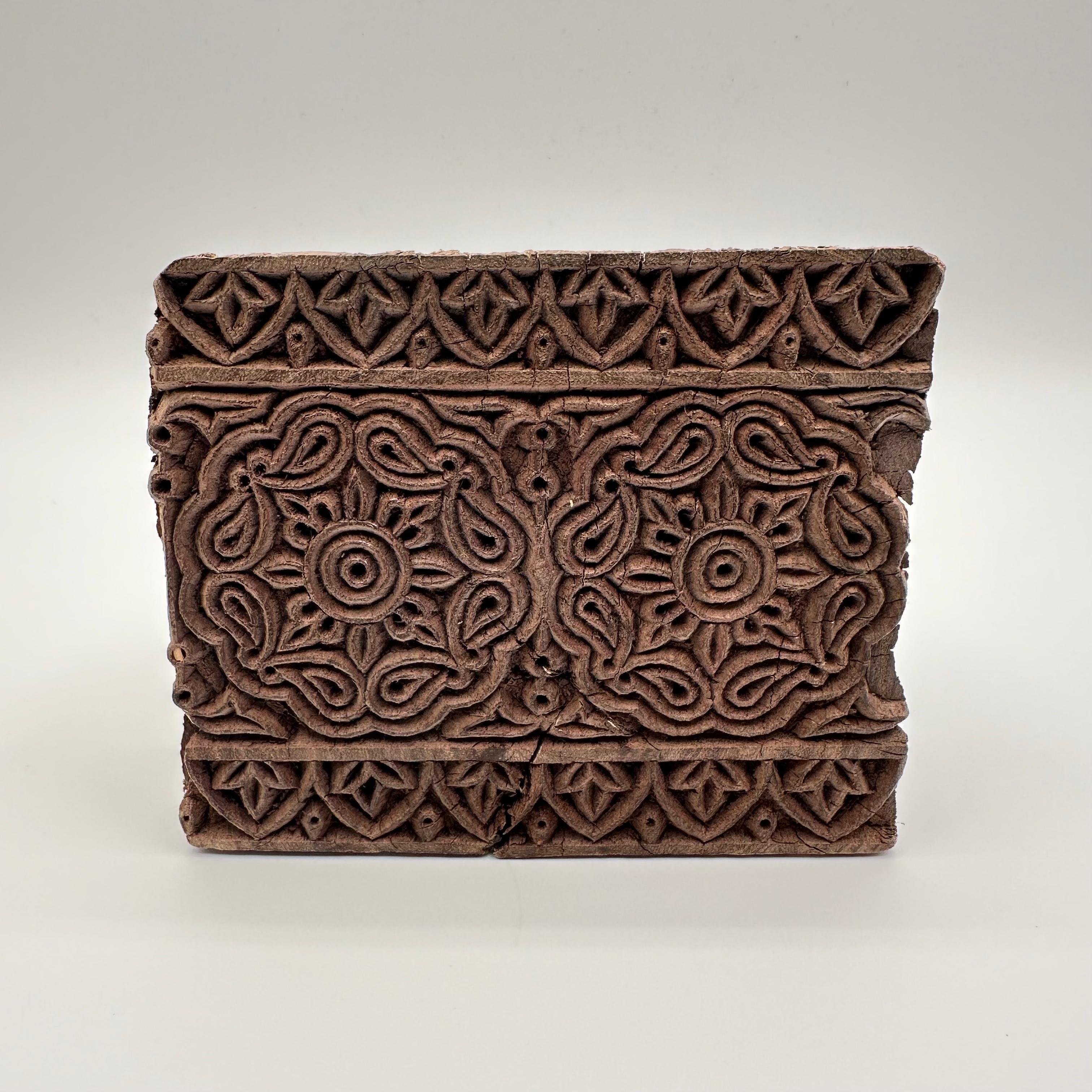 Amazing antique expertly hand-carved wood block with a floral and vegetal pattern that has been used in printing production. This now rustic piece shows signs of years of handling in the daily life of the printing process, while still being