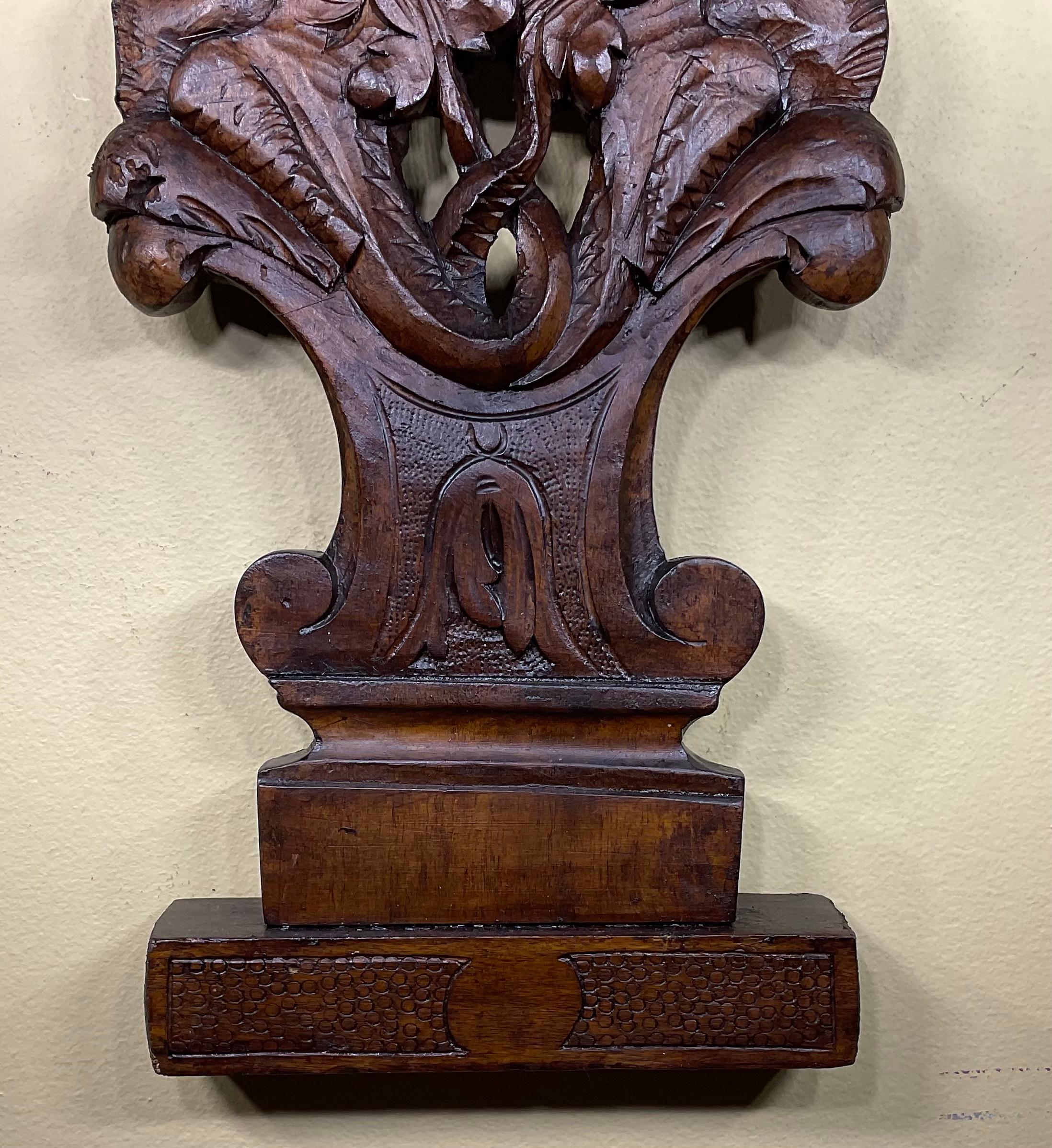Exceptional hand carved Walnut wood sculpture of beautiful cherub face looking forward and very intricate and intriguing bottom carving.
This 19th century decorative piece was salvege from part of antique furniture, restored and refinished to