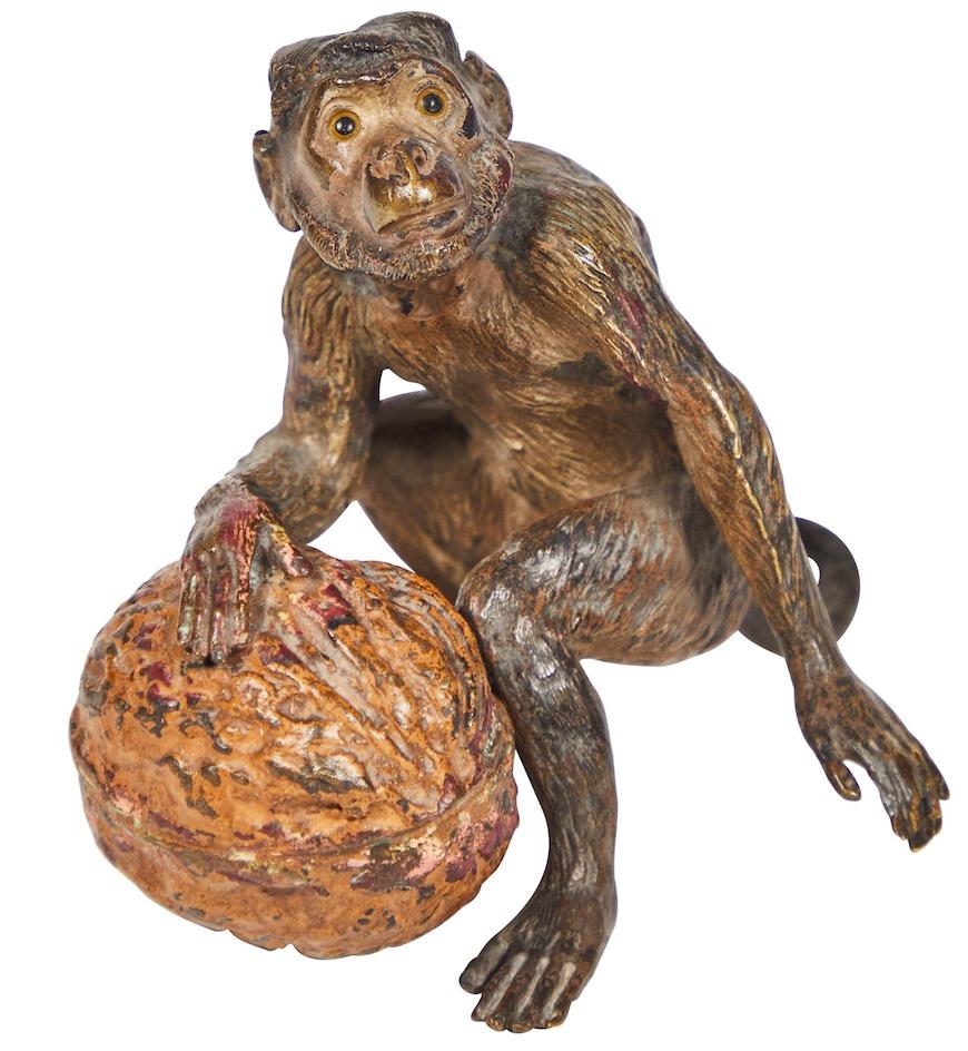 This little Vienna bronze monkey with a life size walnut packs a lot of character into his small size. Cold-painted and cast with impressive detail, he really shines with expression. As seen in the images, there is paint loss and patina from love