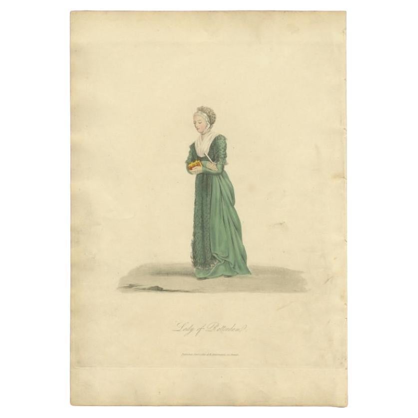 Antique costume print titled 'Lady of Rotterdam'. Old costume print depicting a lady of Rotterdam, the Netherlands. This print originates from 'The Costume of the Netherlands displayed in thirty coloured engravings'. 

Artists and Engravers: Made