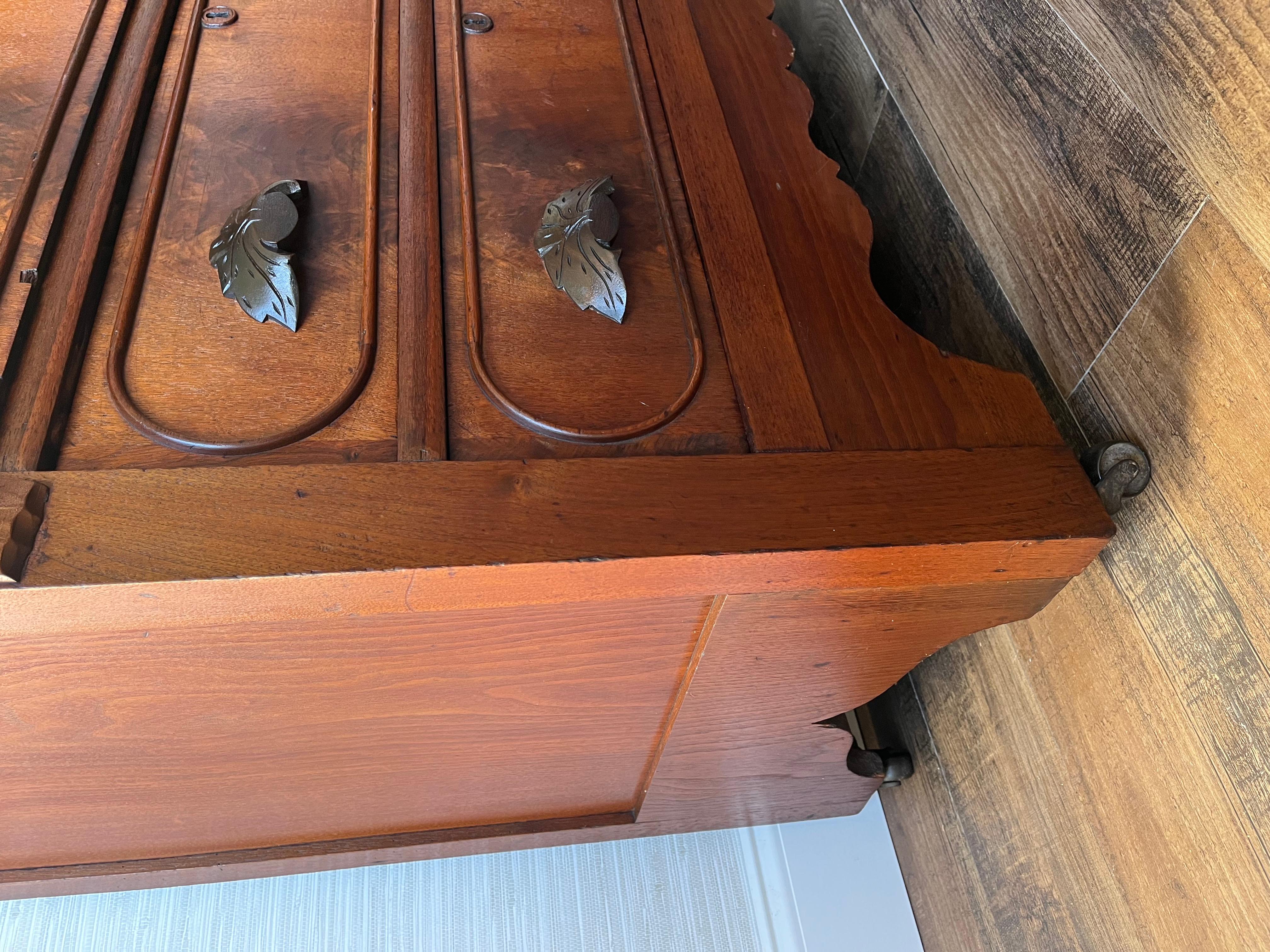 This Eastlake Victorian dresser, hailing from the early 1800s, is imbued with the refined aesthetic of its time. The dresser's burl wood veneer is indicative of its status as a piece belonging to a discerning middle to upper-middle class Victorian