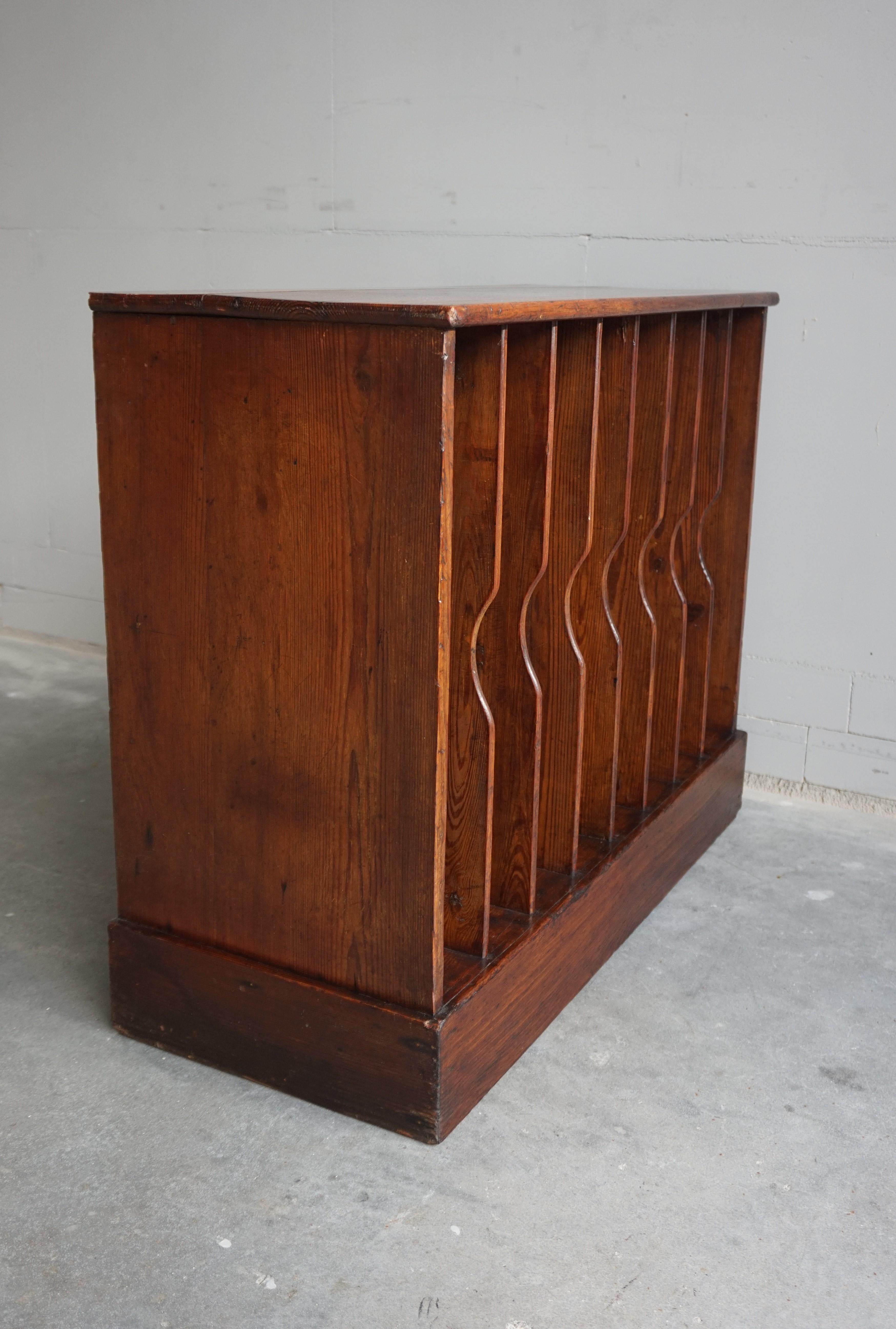 Multi purpose and practical size floor cabinet from the early 1900s.

We may never know what this practical and good looking cabinet was initially made for, but we found it filled with bottles of red wine. With eight compartments holding up to seven