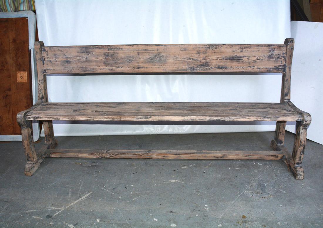 The antique rustic country bench is handcrafted with solid curved framing and a comfortable slanted back. The back has been given extra strength with 