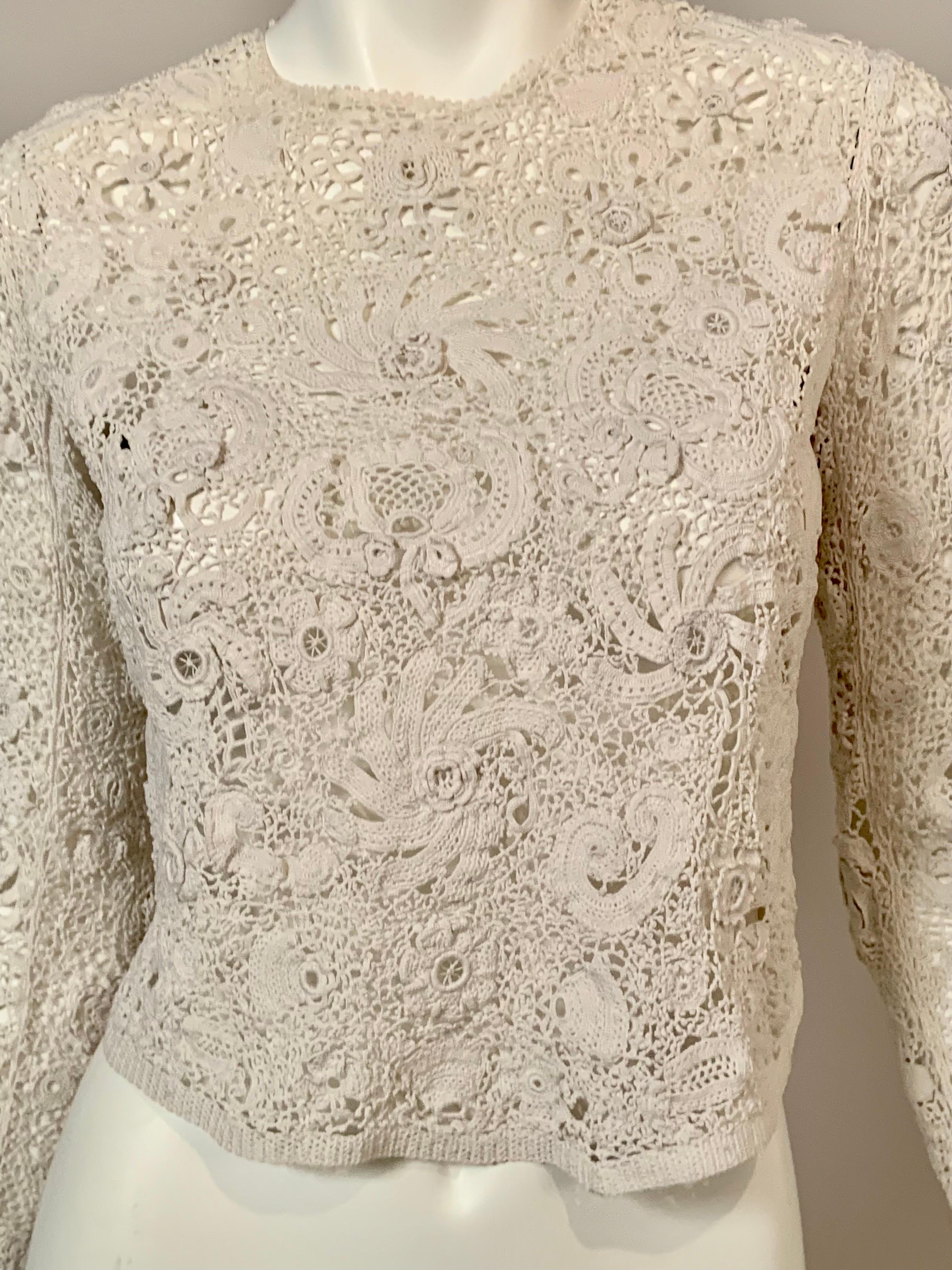 This beautiful handmade Irish lace or Irish crochet blouse is very well designed and thought out.  The blouse has a variety of floral and leaf motifs as well as a few shamrocks. These designs are either flat or three dimensional adding more interest